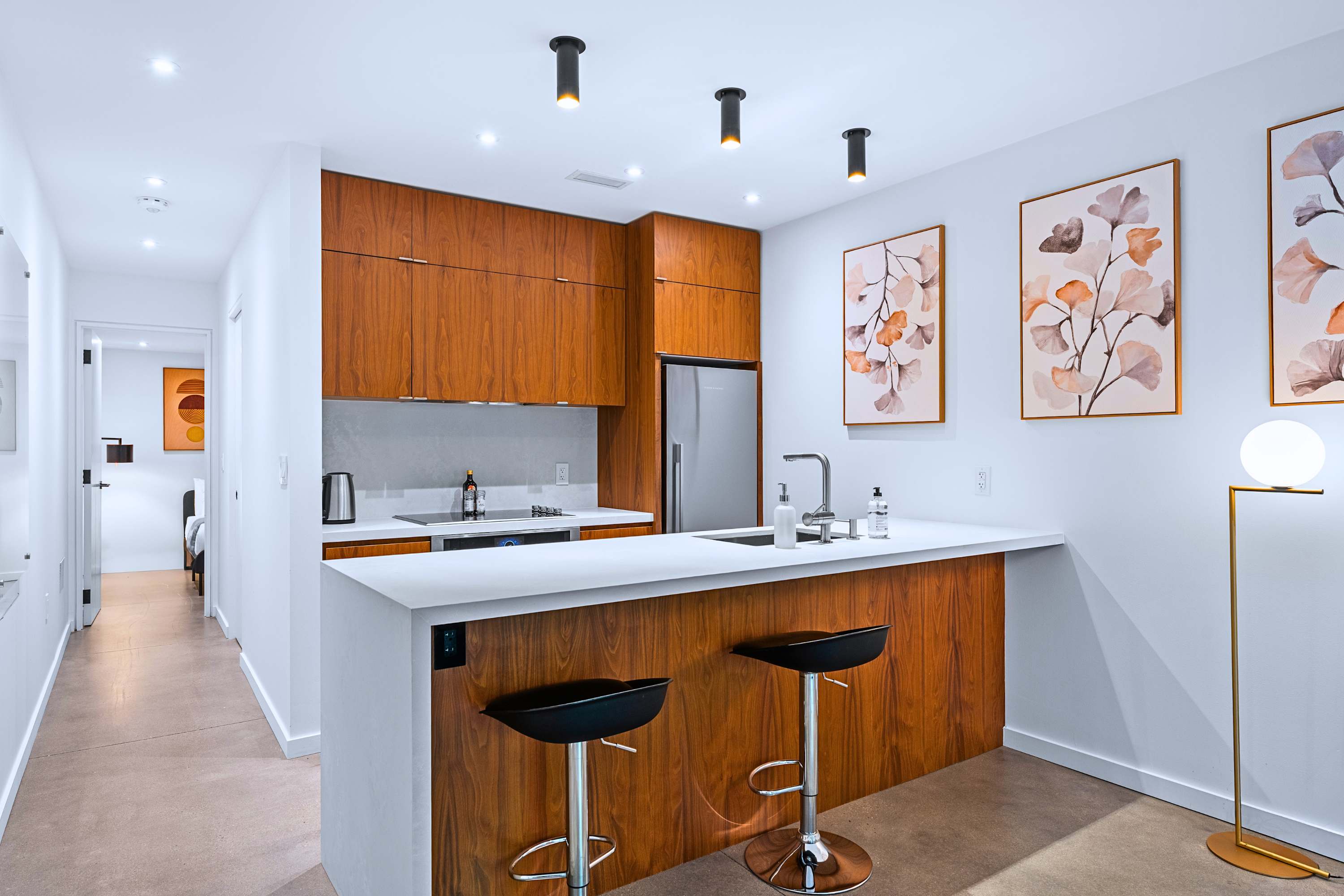 Seamless hallway layout connects culinary and entertaining spaces effortlessly.