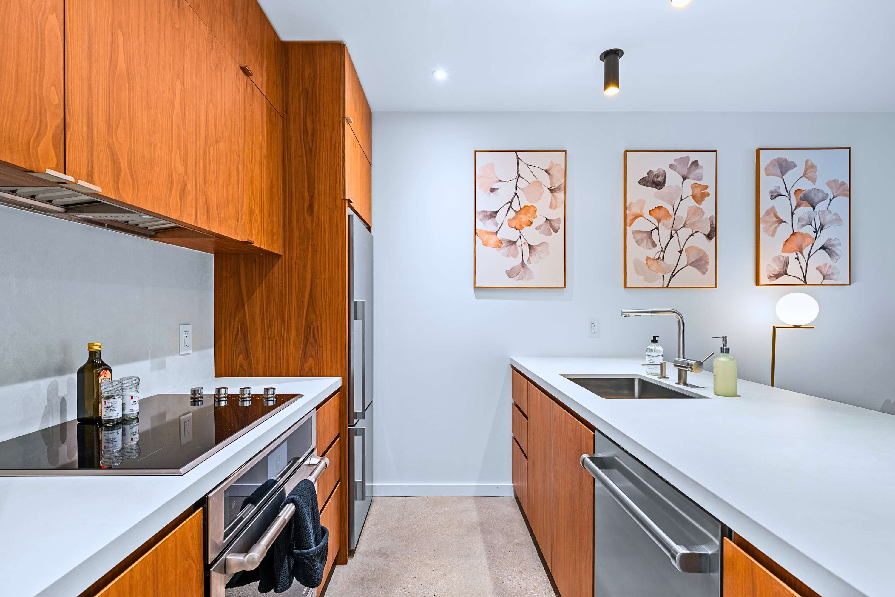 Flush-mount induction cooktop paired with rich wood cabinetry.