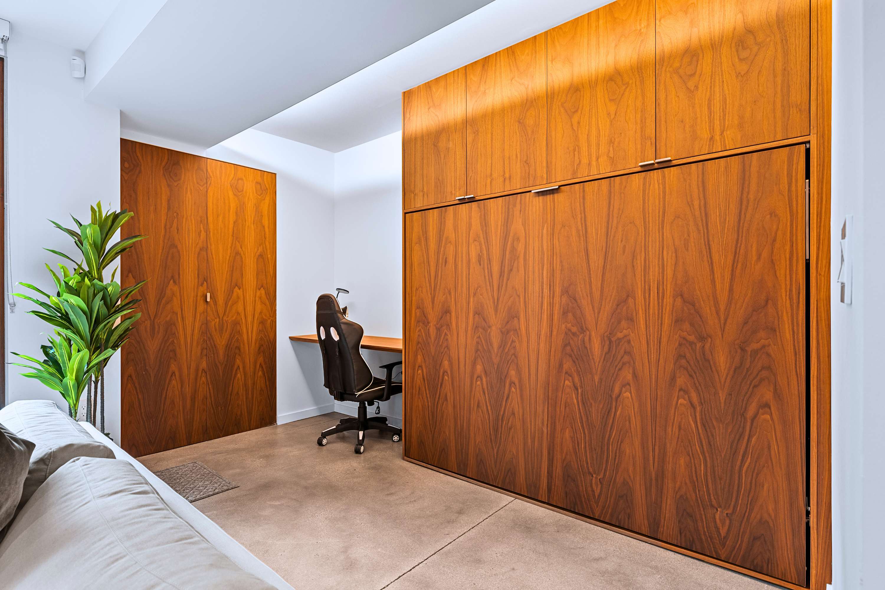 Living zone workstation that converts into extra sleeping space.
