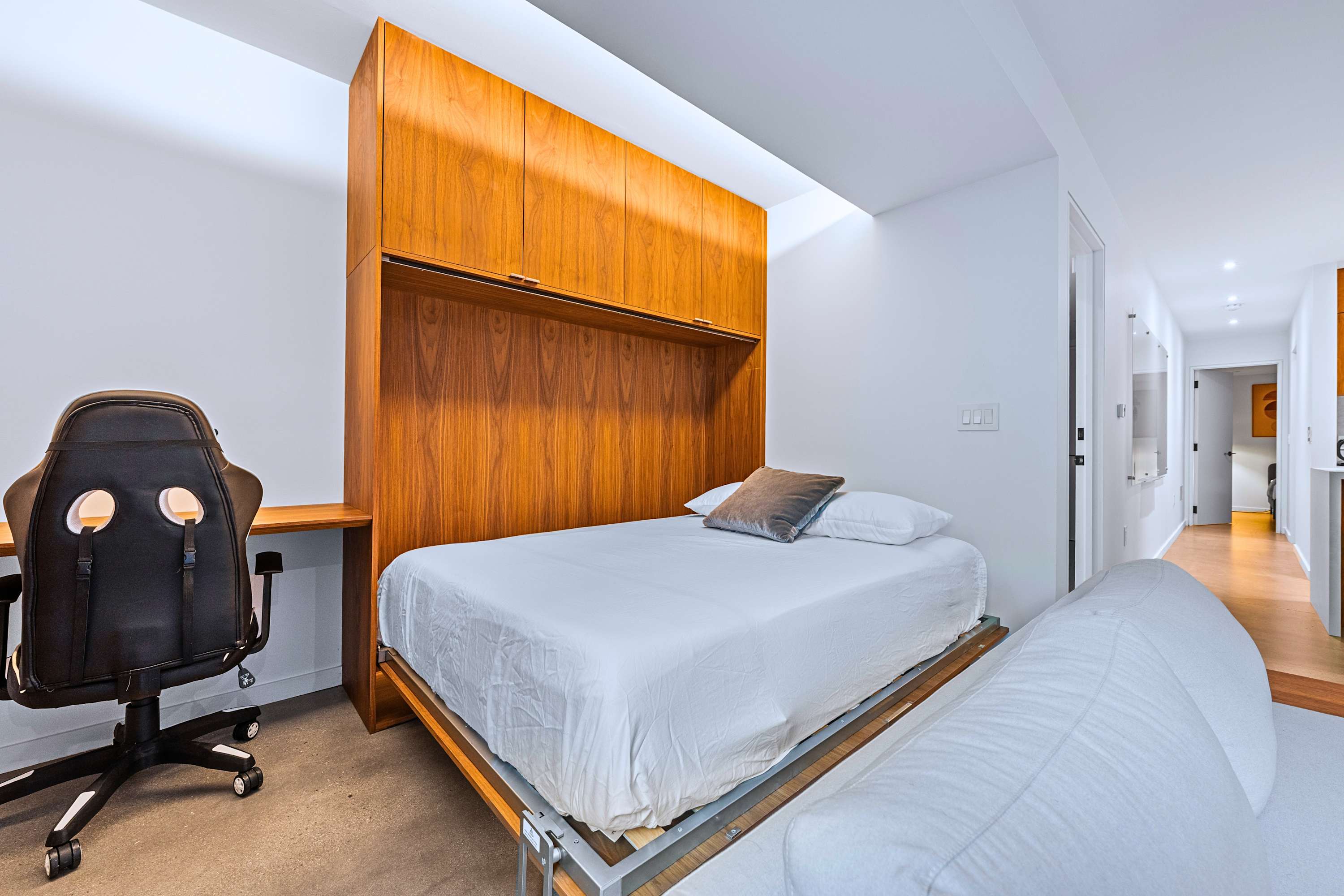 Queen pull-down Murphy bed converts workstation into added sleeping space.