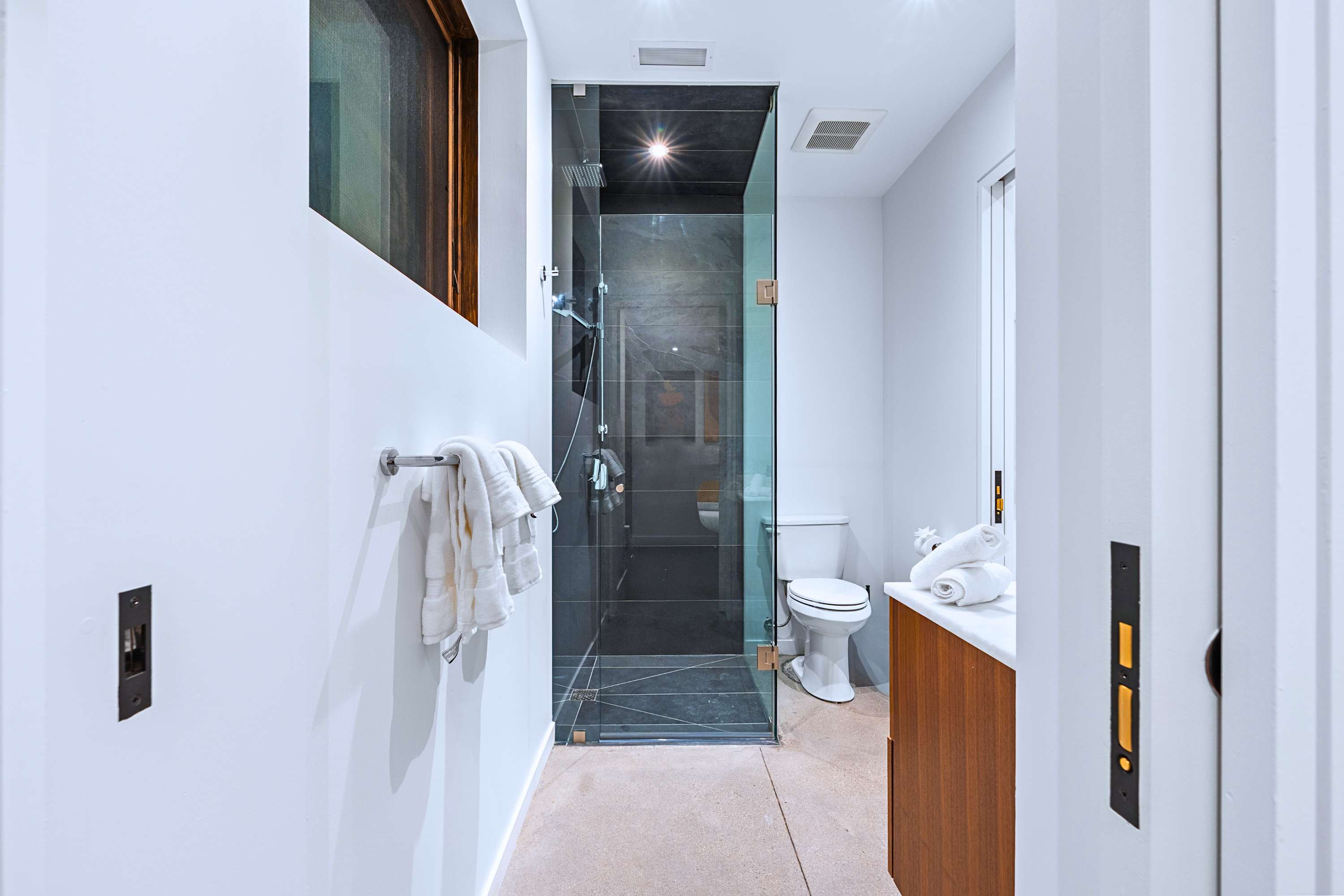 En-suite bath with glass shower enclosure and premium fixtures.