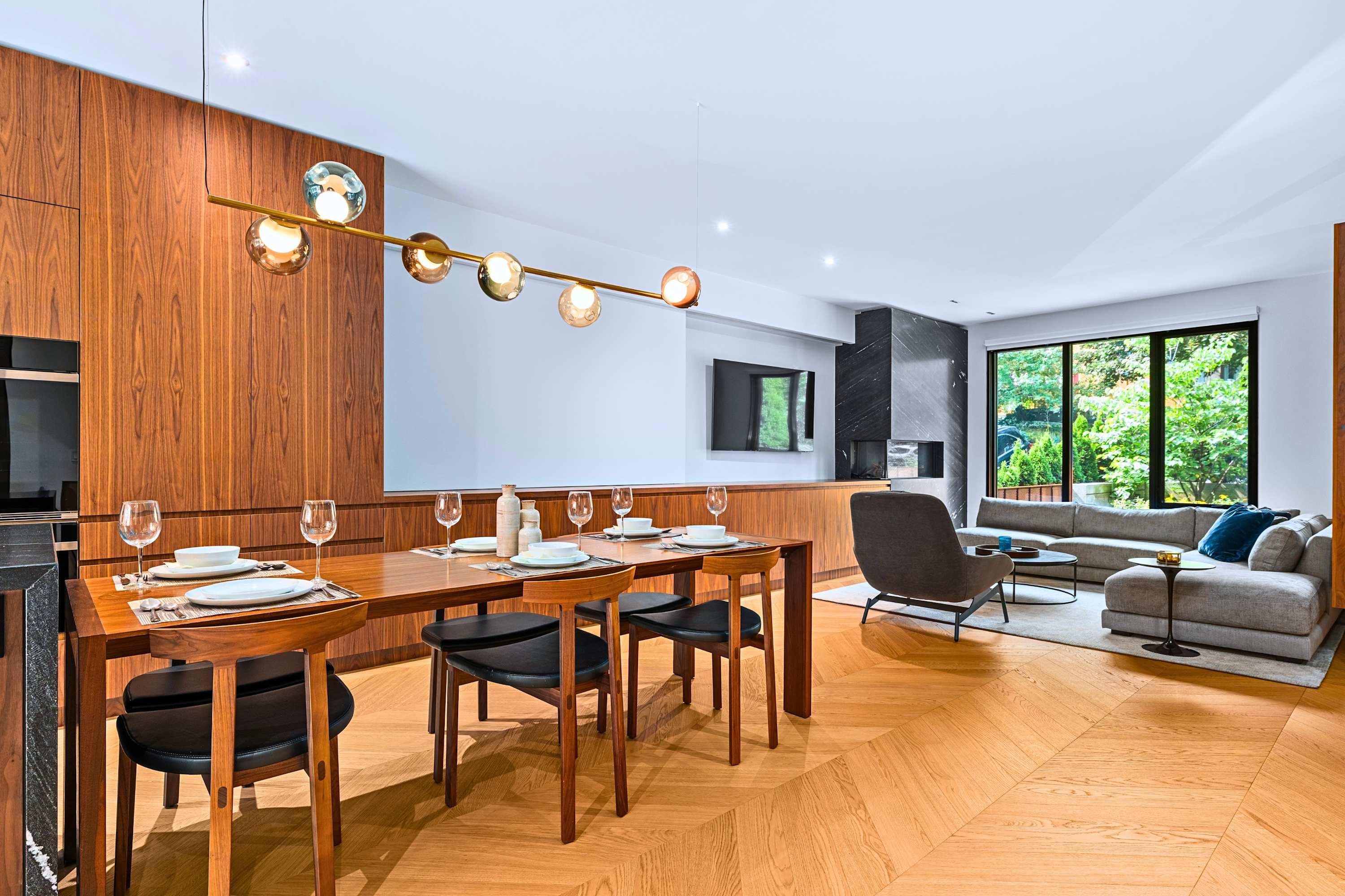 Formal dining setup connected directly to light-filled living spaces.