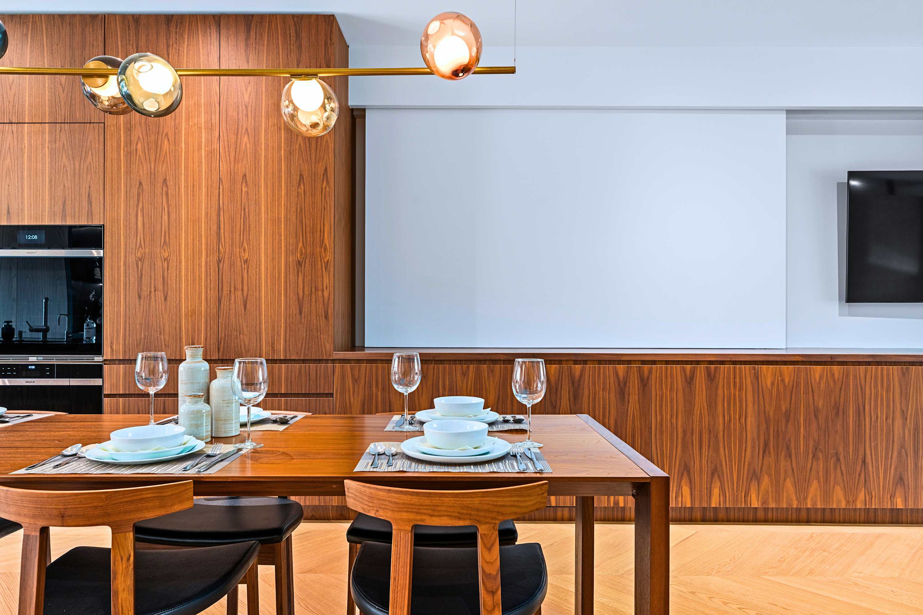 Spacious dining room setting equipped for multi-course dinner hosting.