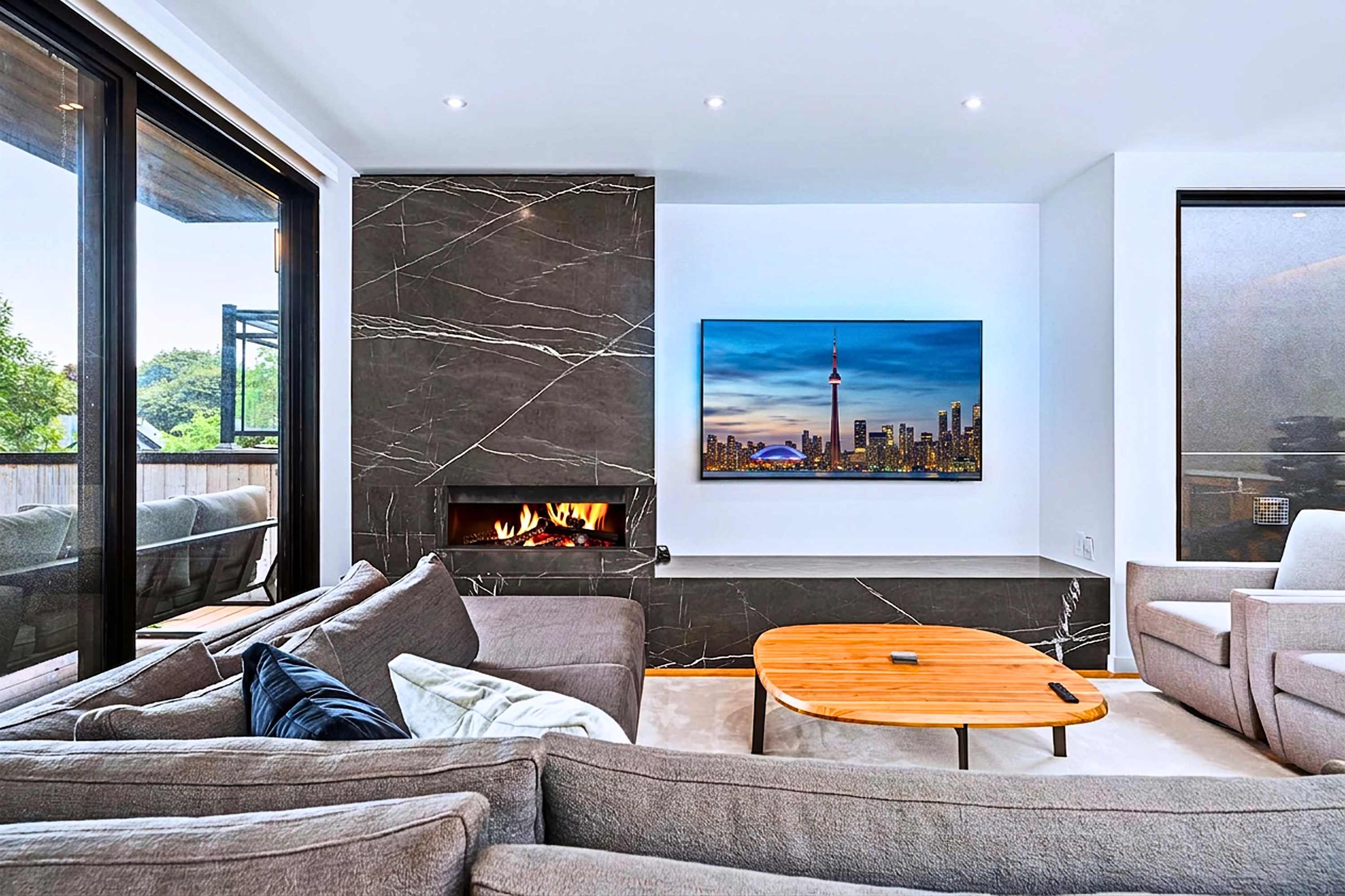 Luxe living room centered on a stone-feature fireplace and smart TV.