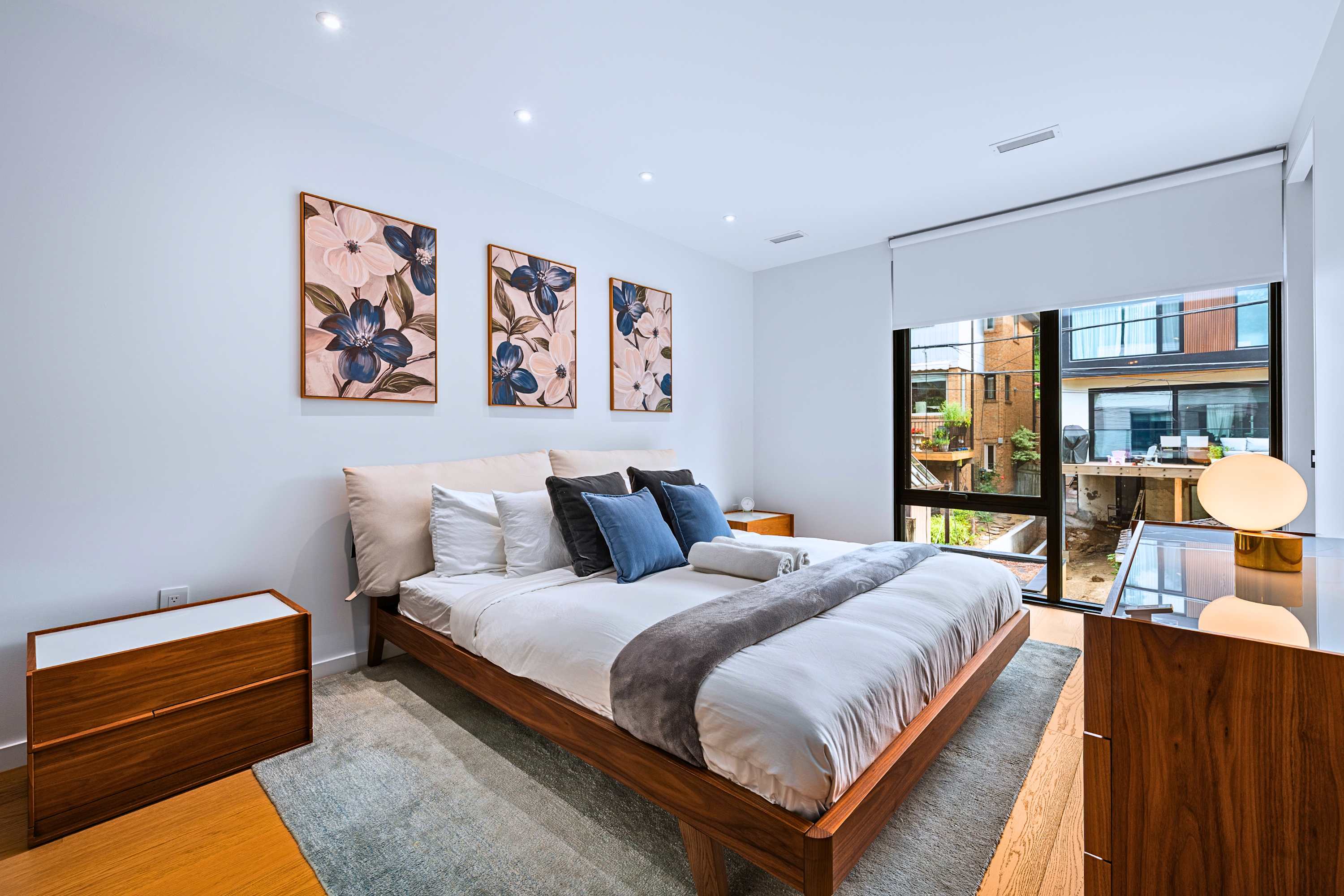 Generous king suite with large windows, plush linens, and built-in closet.