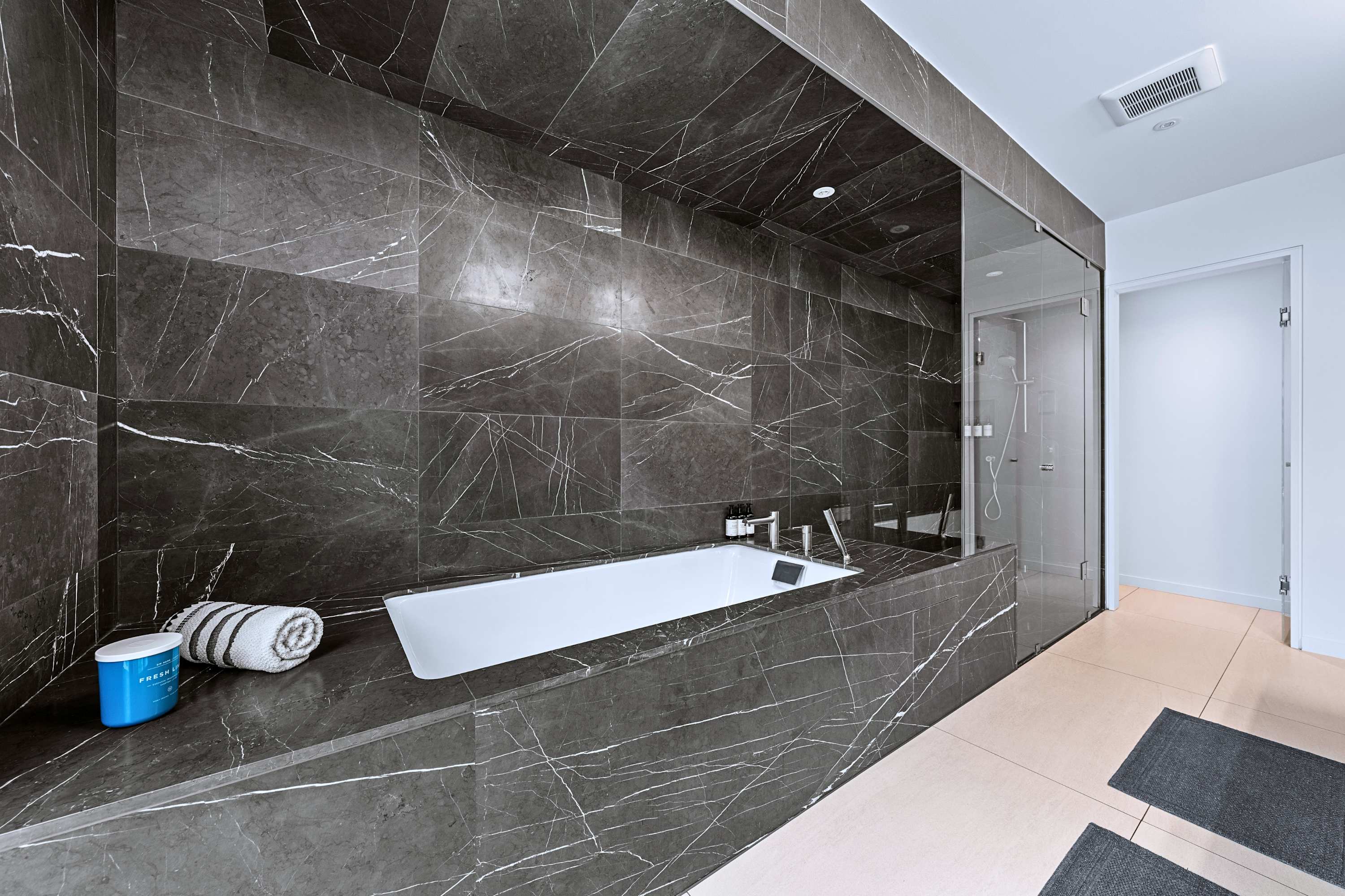 Spa-inspired soaker tub set against a dramatic dark tile accent wall.