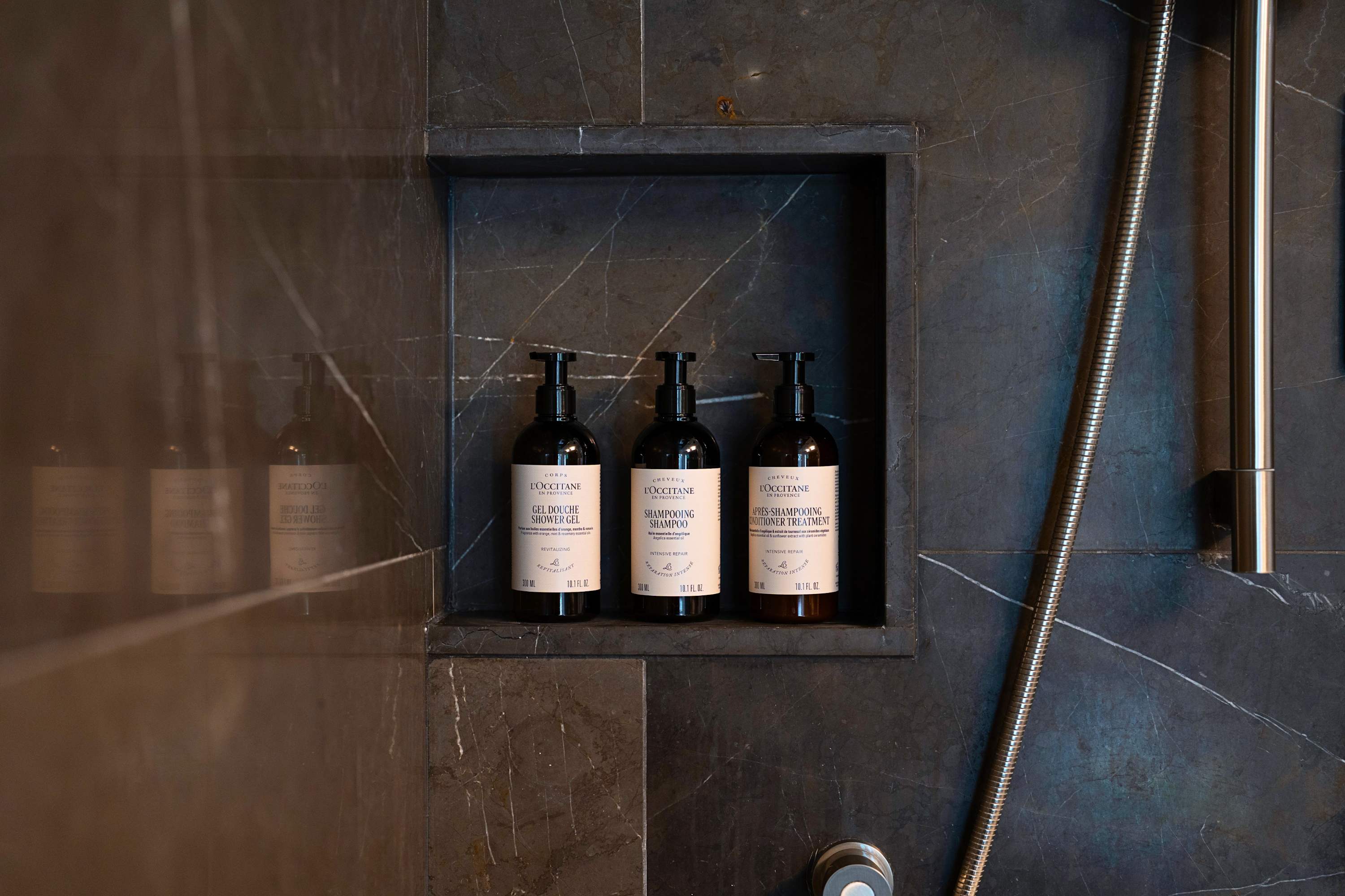 Shower stocked with complimentary premium guest toiletries.