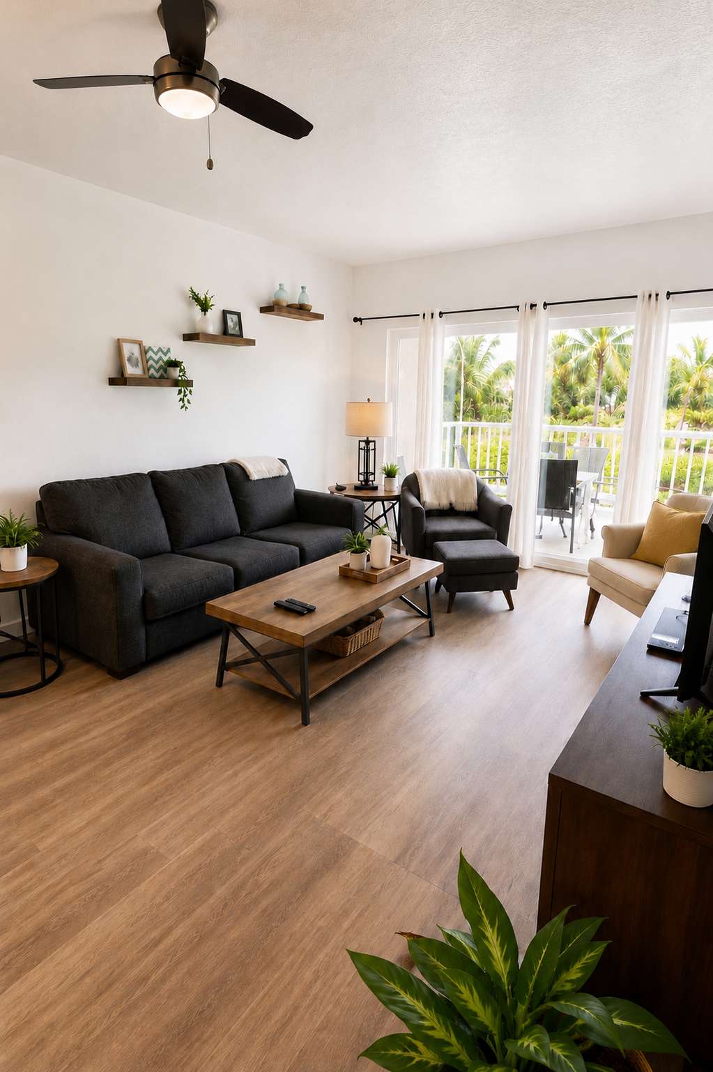 Living Room with balcony overlooking gardens and swimming pool.