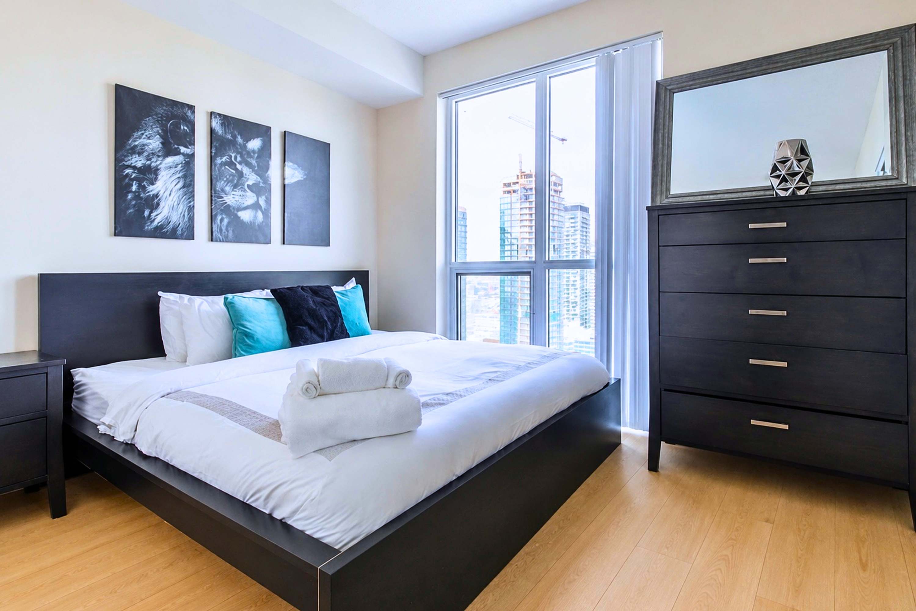 Rest easy: King bed, crisp linens, city views & built-in storage.