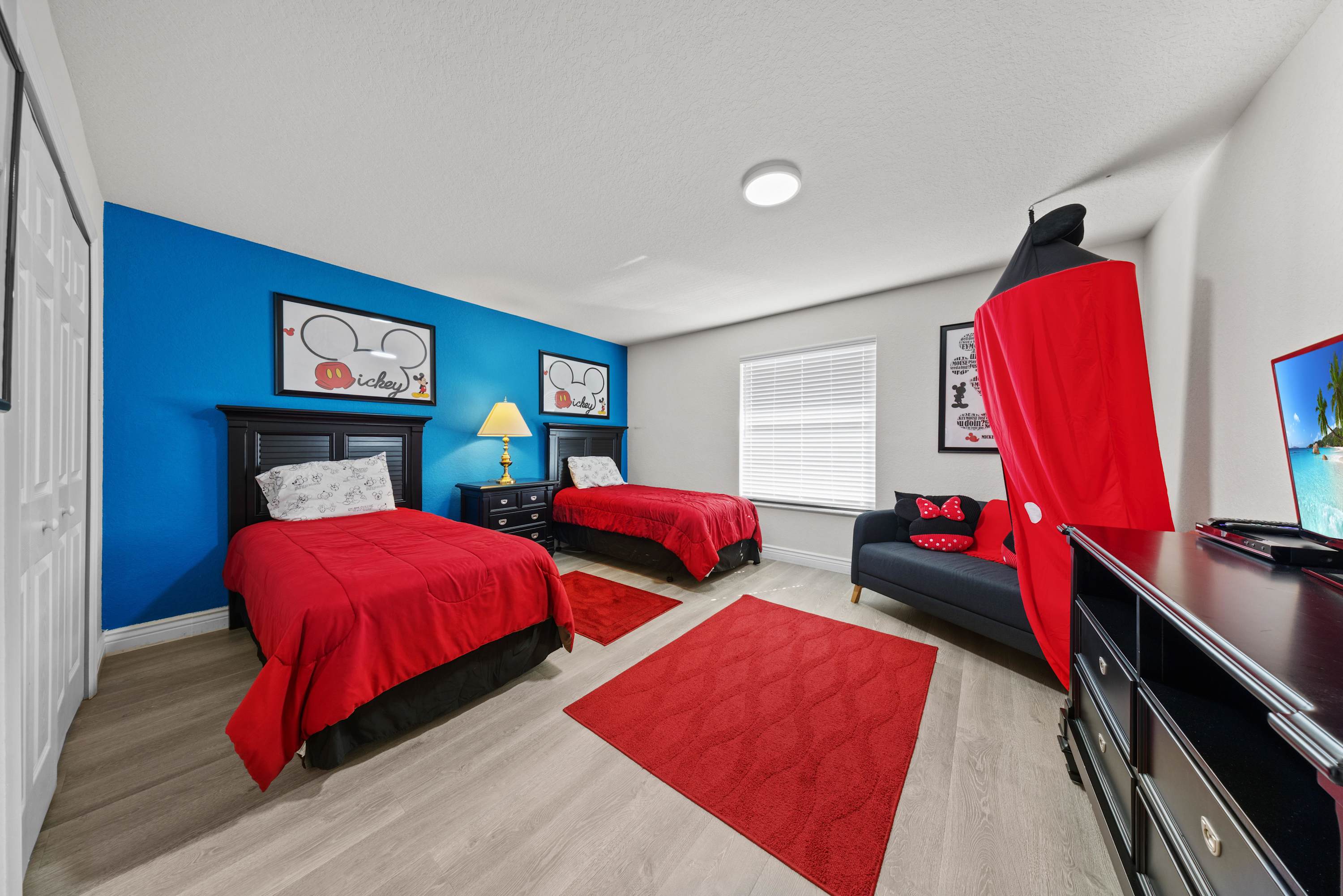 Sweet dreams await in this classic Mickey-themed room with a Smart TV