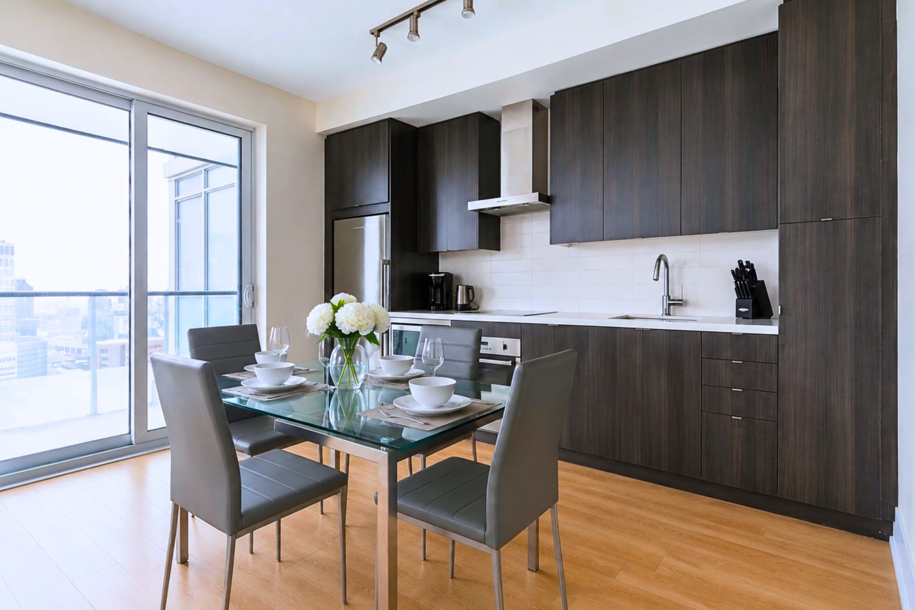 Clean, fully stocked kitchen paired with a cozy dining space.