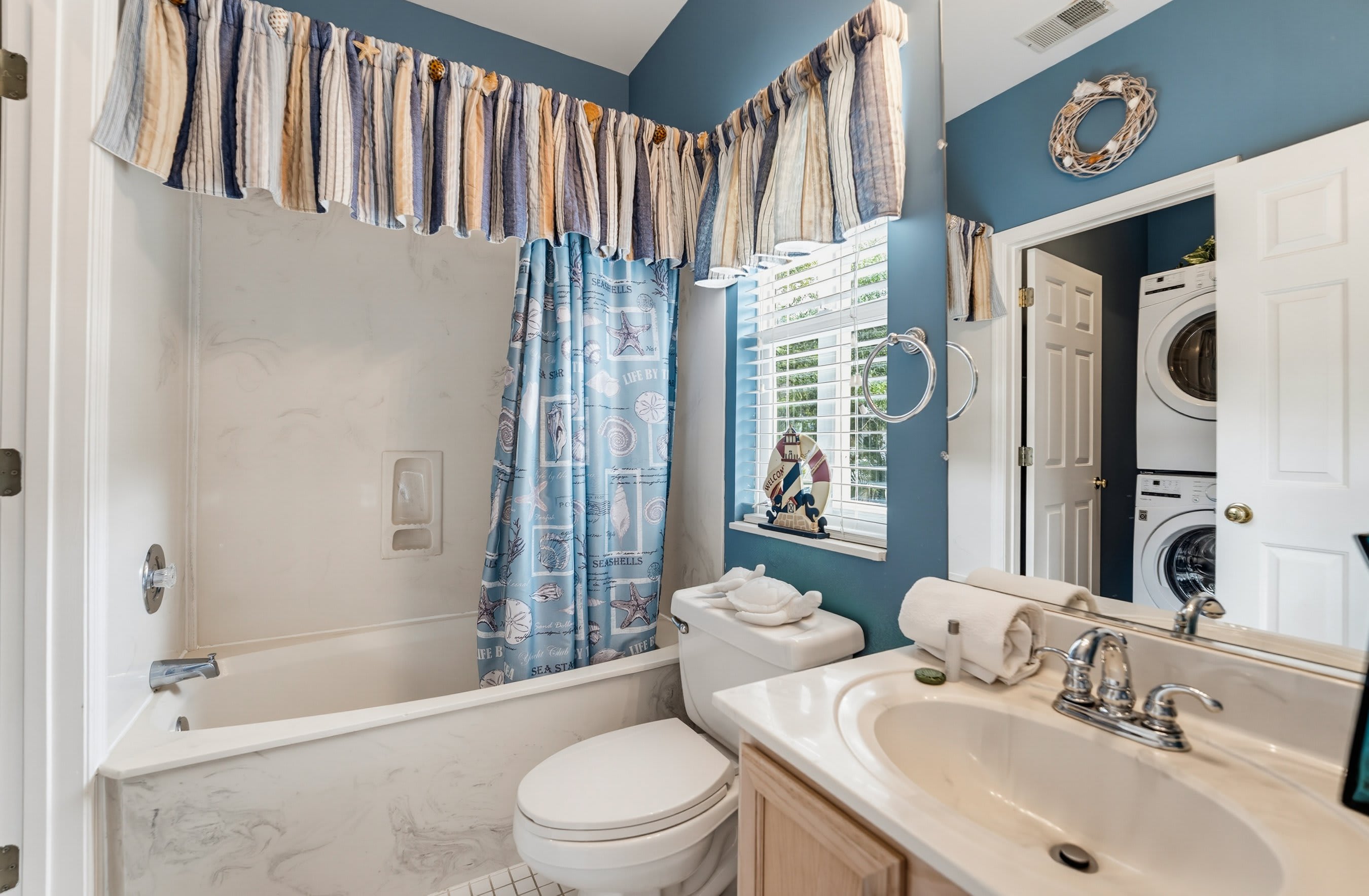 Guest Bathroom with Tub/Shower Combo and Laundry Room