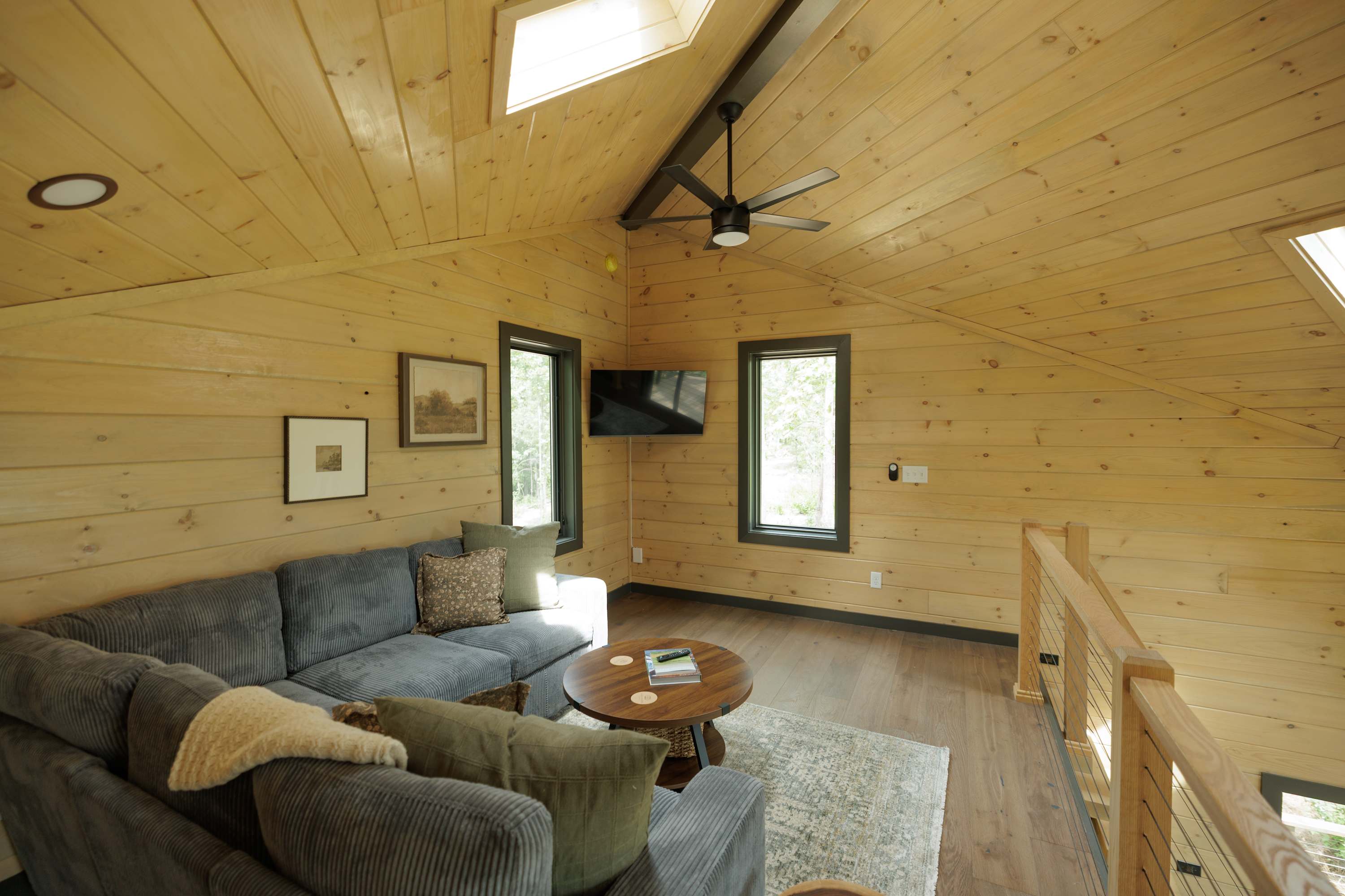 Open living area featuring comfortable seating and a charming loft.