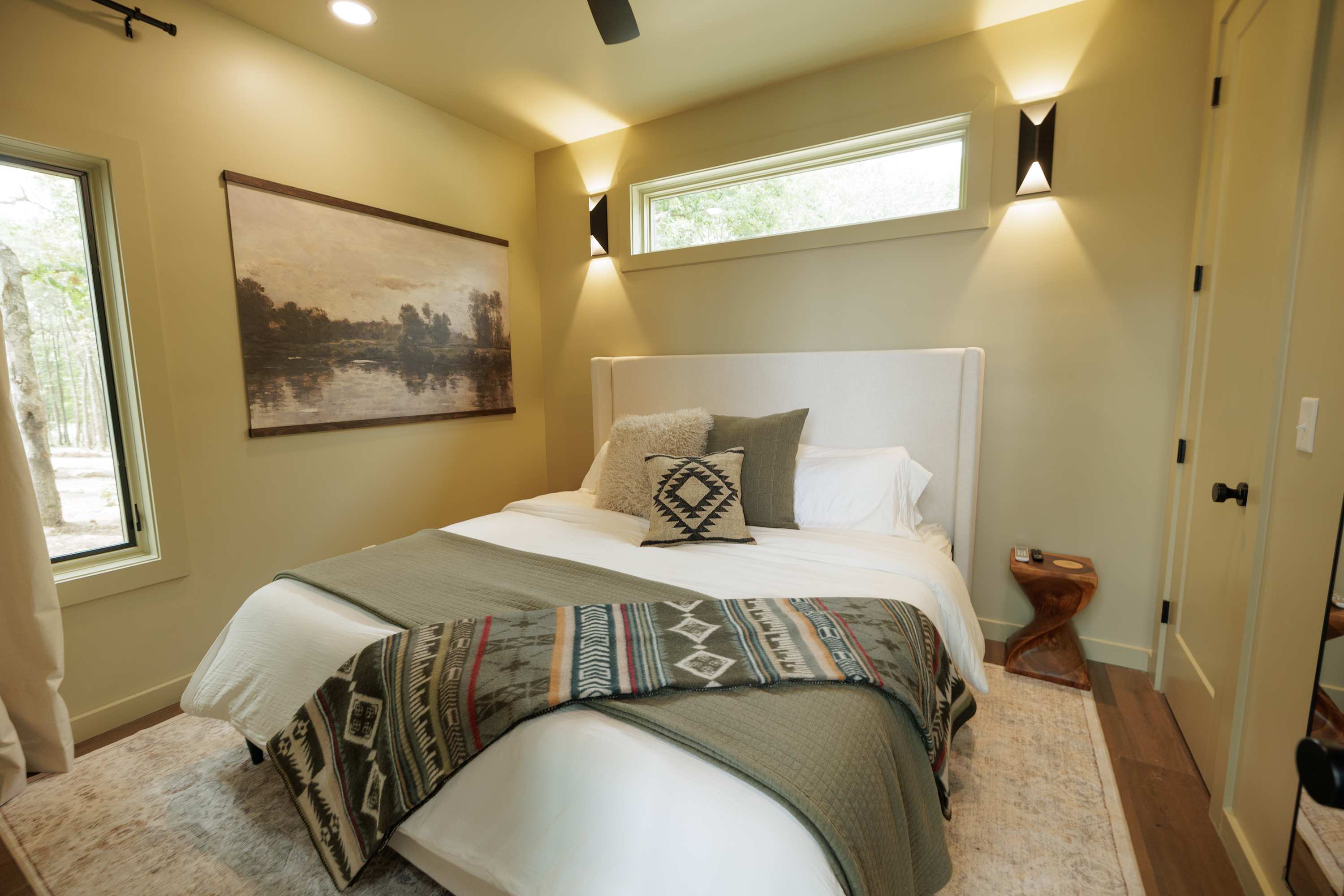 Bedroom offers a cozy space with a comfortable bed and peaceful woodland views.
