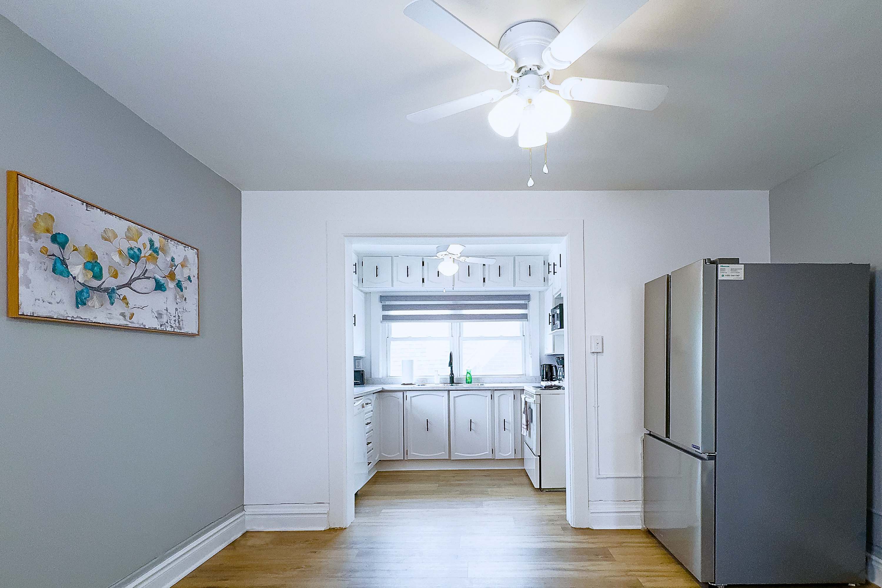 A Bright And Spacious Dining Area Leading Into A Modern Kitchen