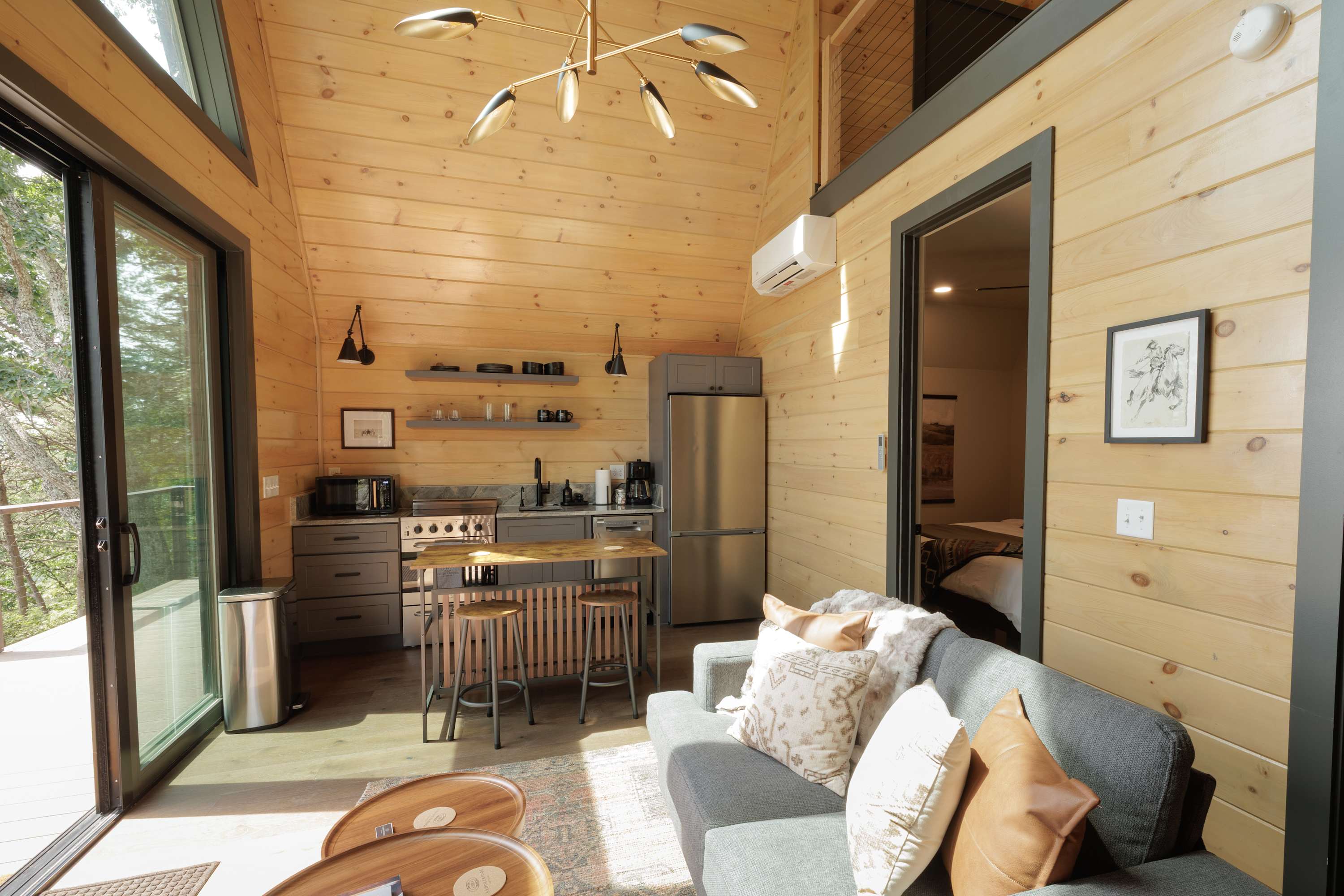 Open-concept cabin with a kitchen, dining area, and cozy seating.