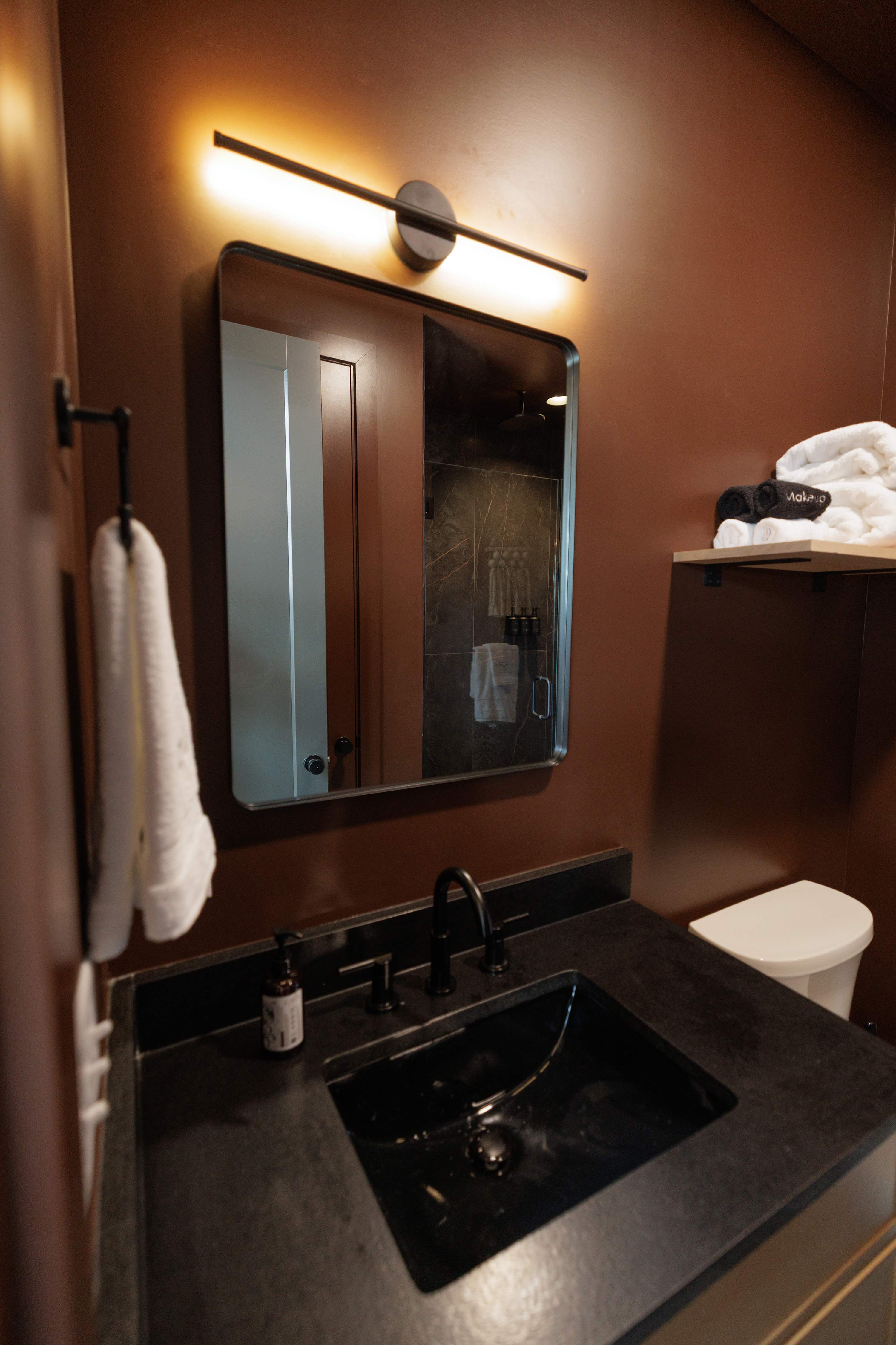 Modern vanity with fresh towels and everyday essentials.