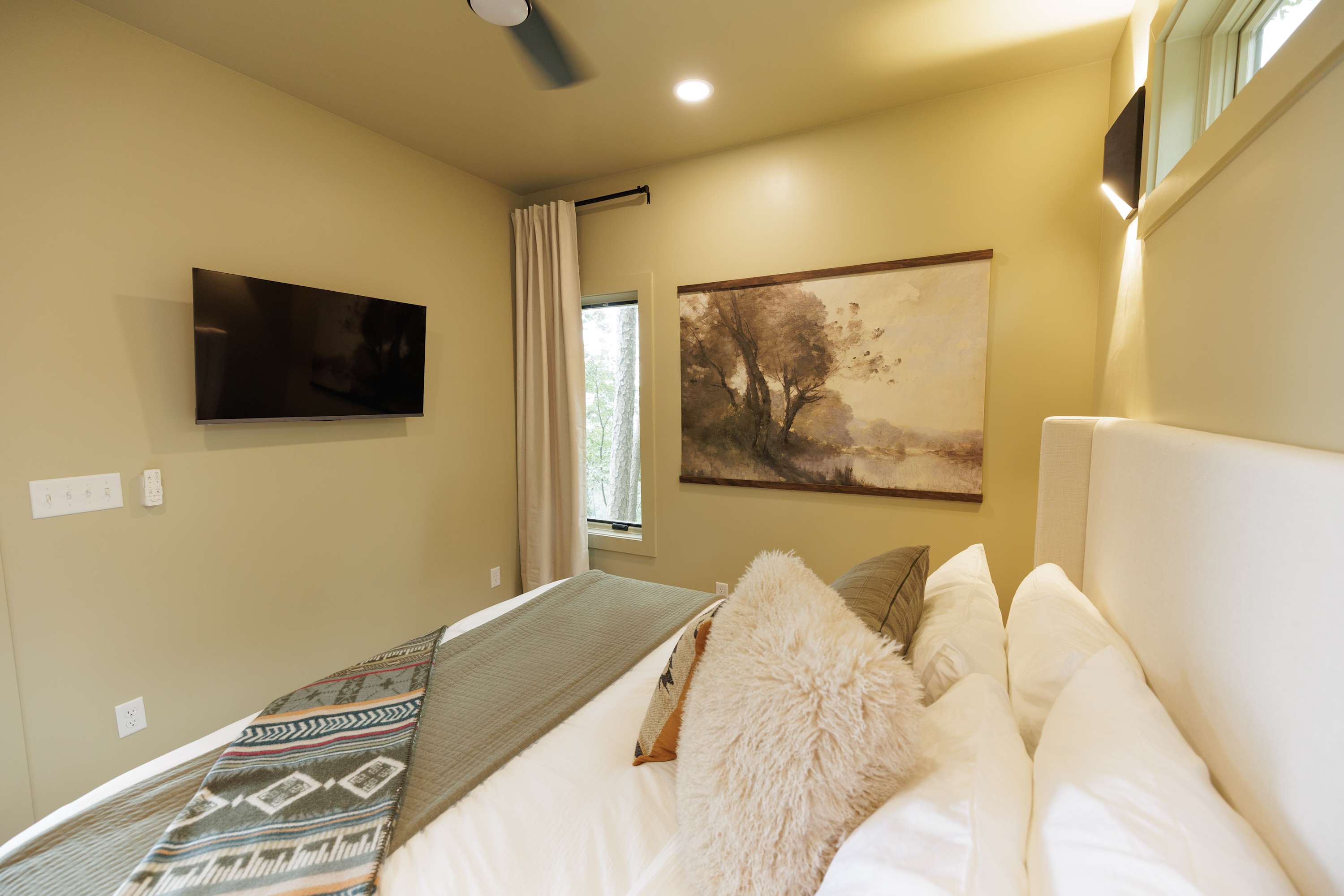 Soft bedding and warm tones create a relaxing retreat.