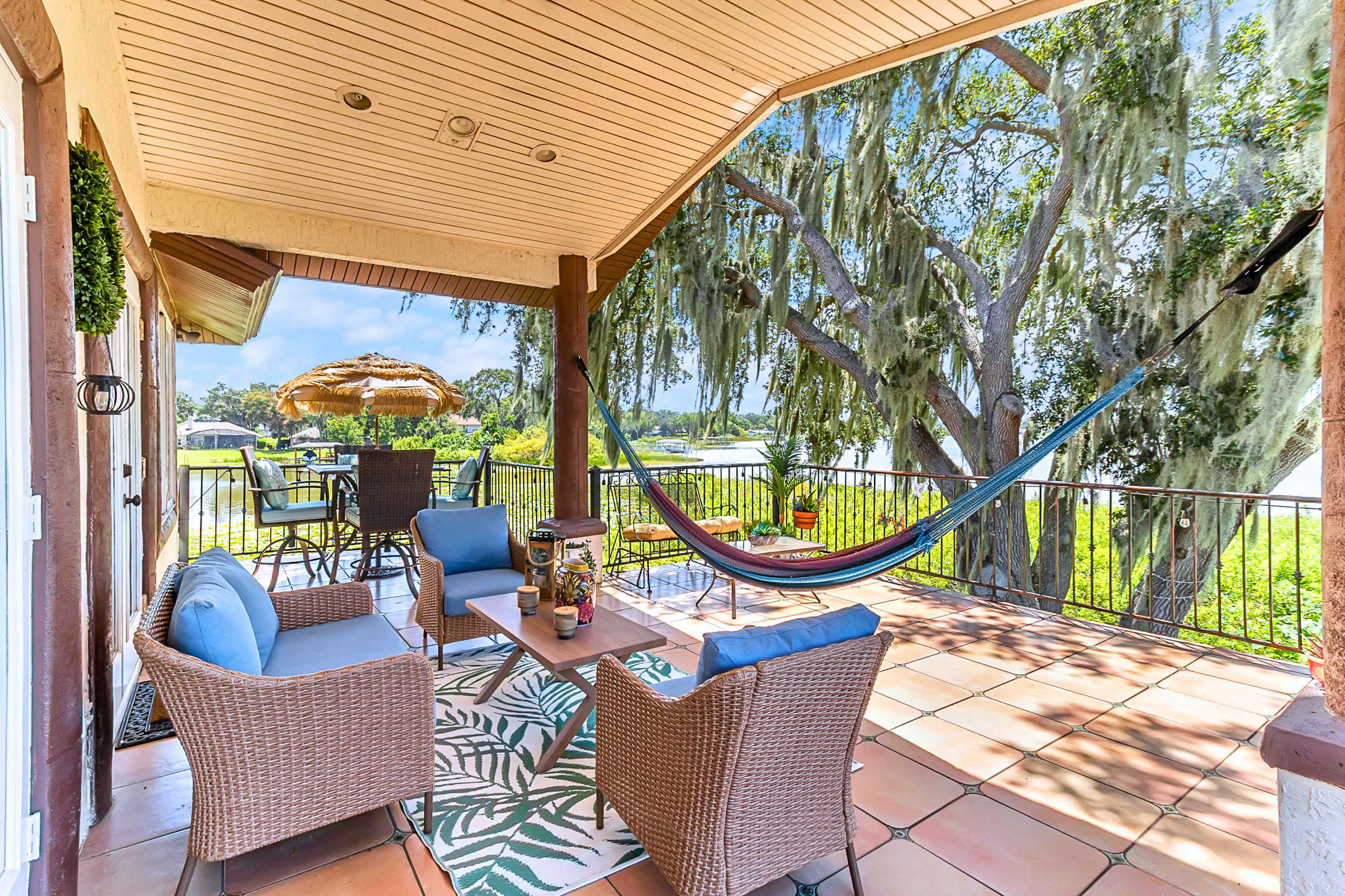 Enjoy outdoor dining or relax on the lounge couch and hammock overlooking the lake