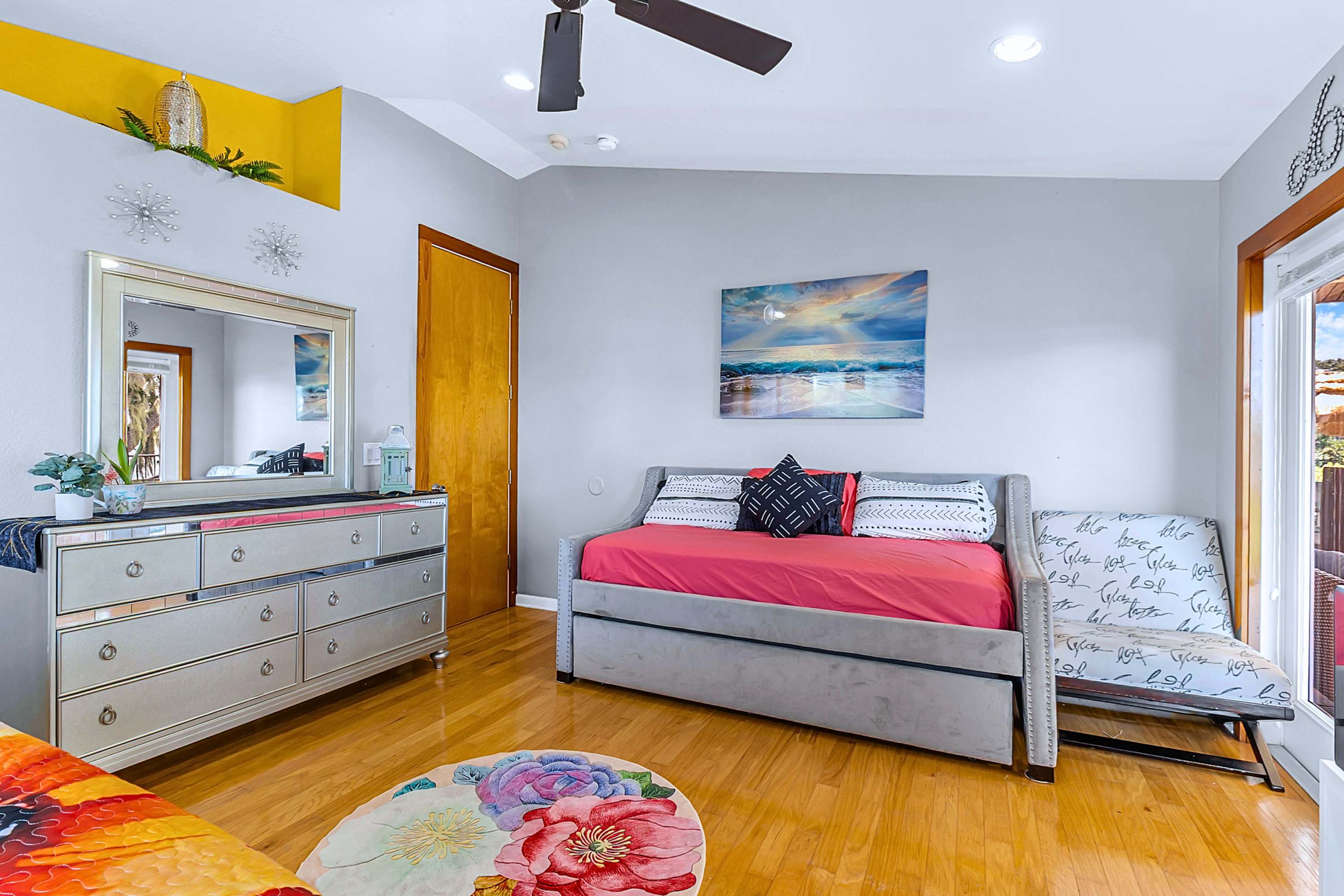Relax with a sleeper sofa, extra pullout bed, cozy side chair, mirror cabinet, and fan