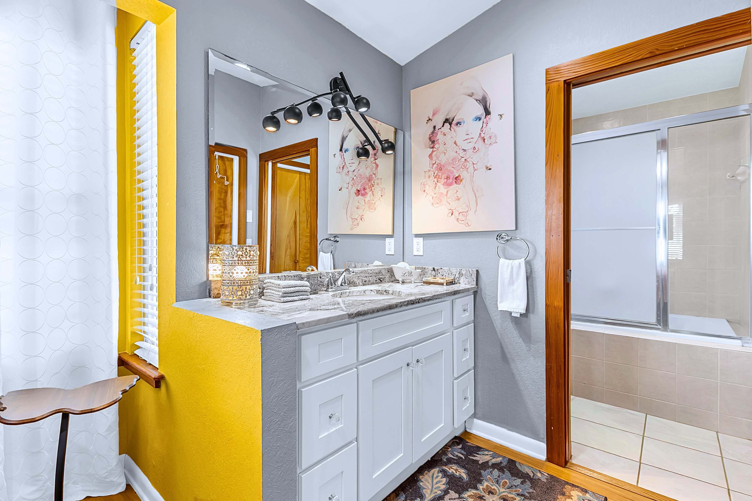 Step out to a sleek vanity mirror, cabinet storage, and easy bathroom access