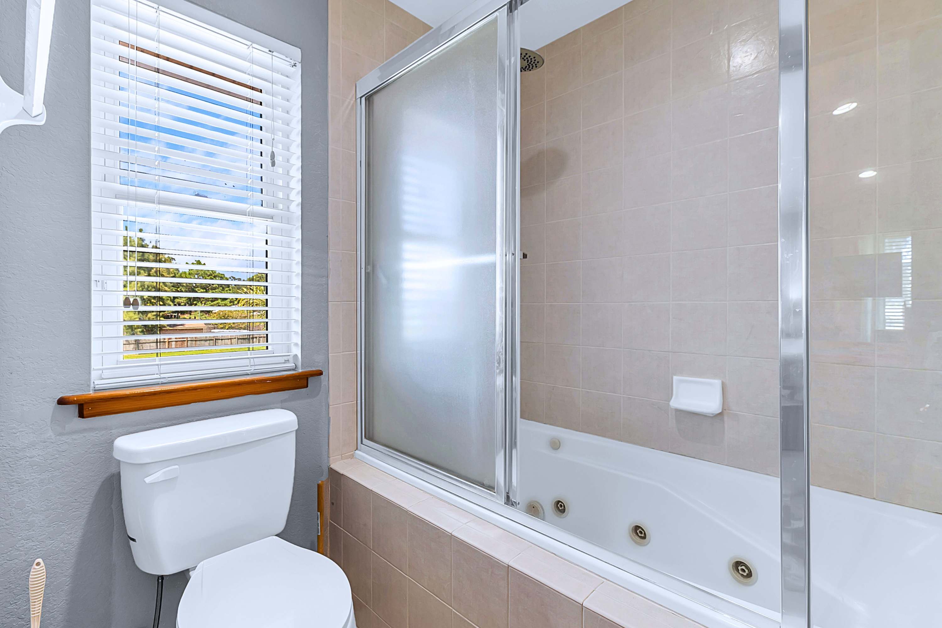 Complete bathroom featuring a deep soaking tub shower combination for total relaxation