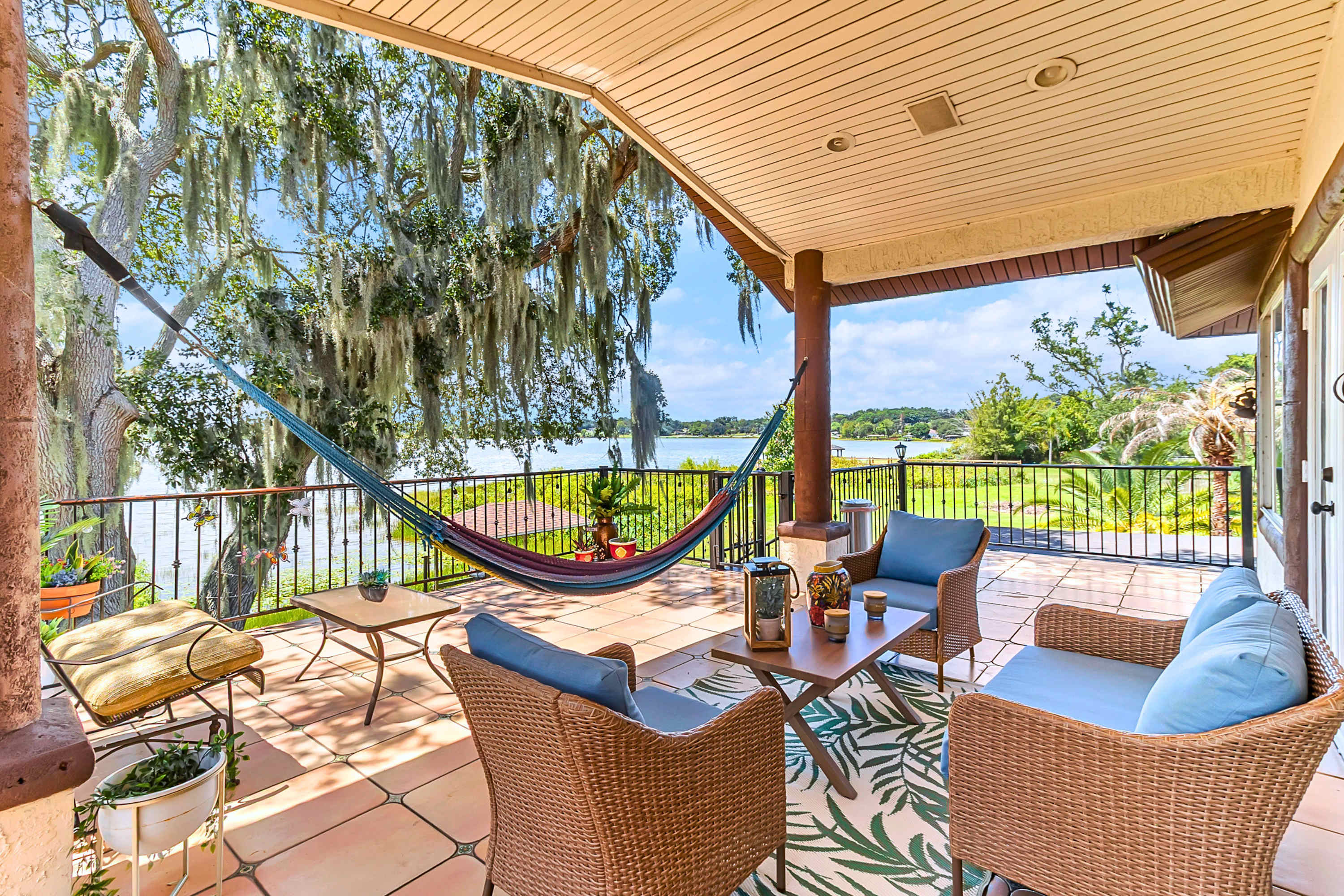 Catch the breeze on our lakeview terrace featuring cozy lounge seating and a hammock