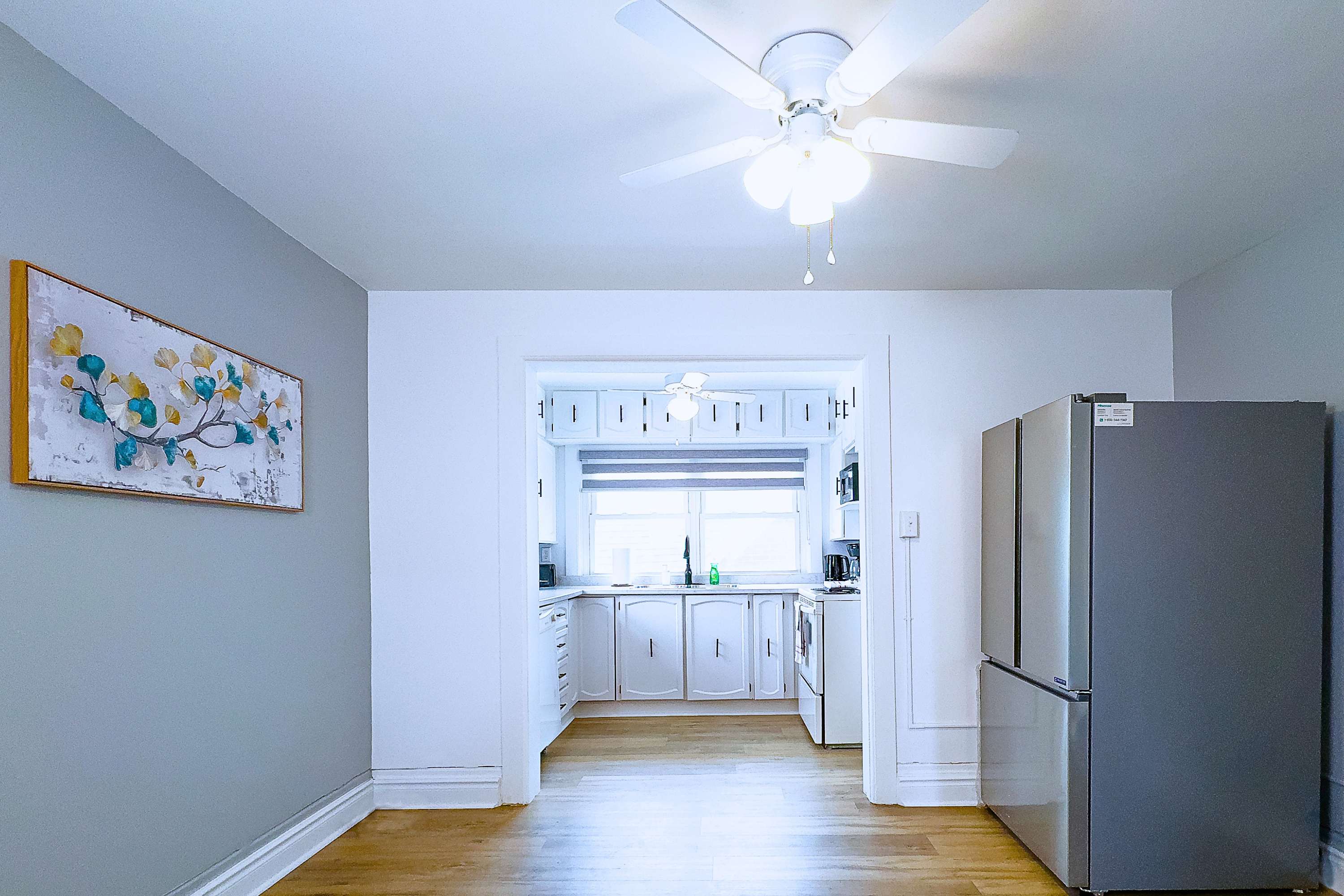 A Bright And Spacious Dining Area Leading Into A Modern Kitchen