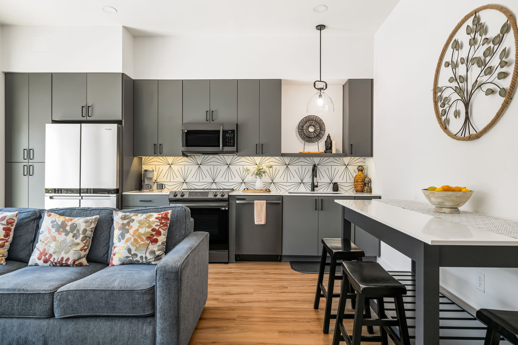 Kitchen with dark cabinetry and high-top seating
