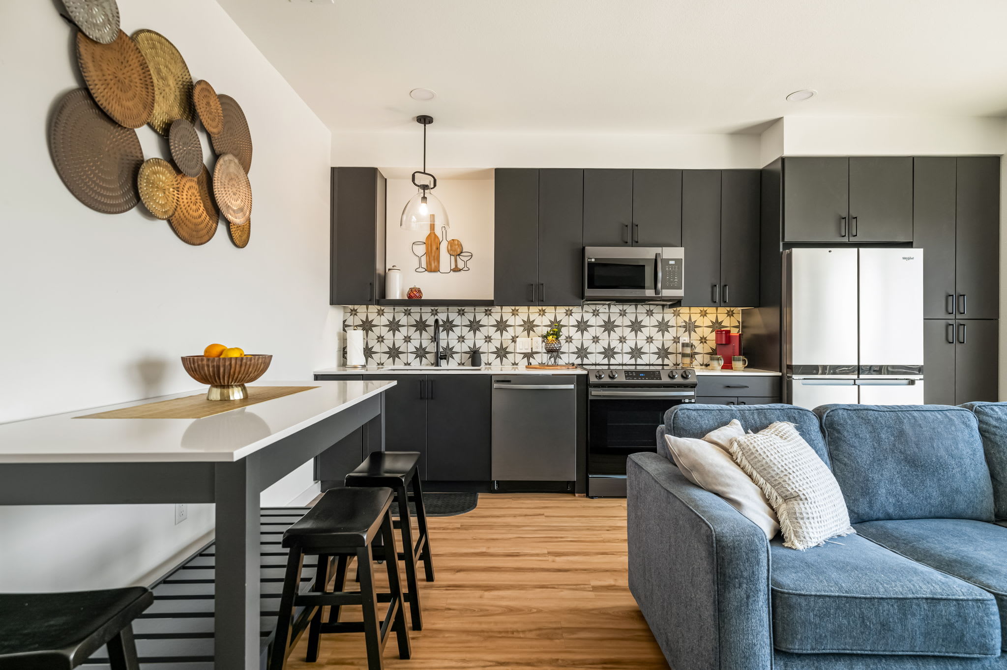 Kitchen with high-top table and patterned tile backsplash
