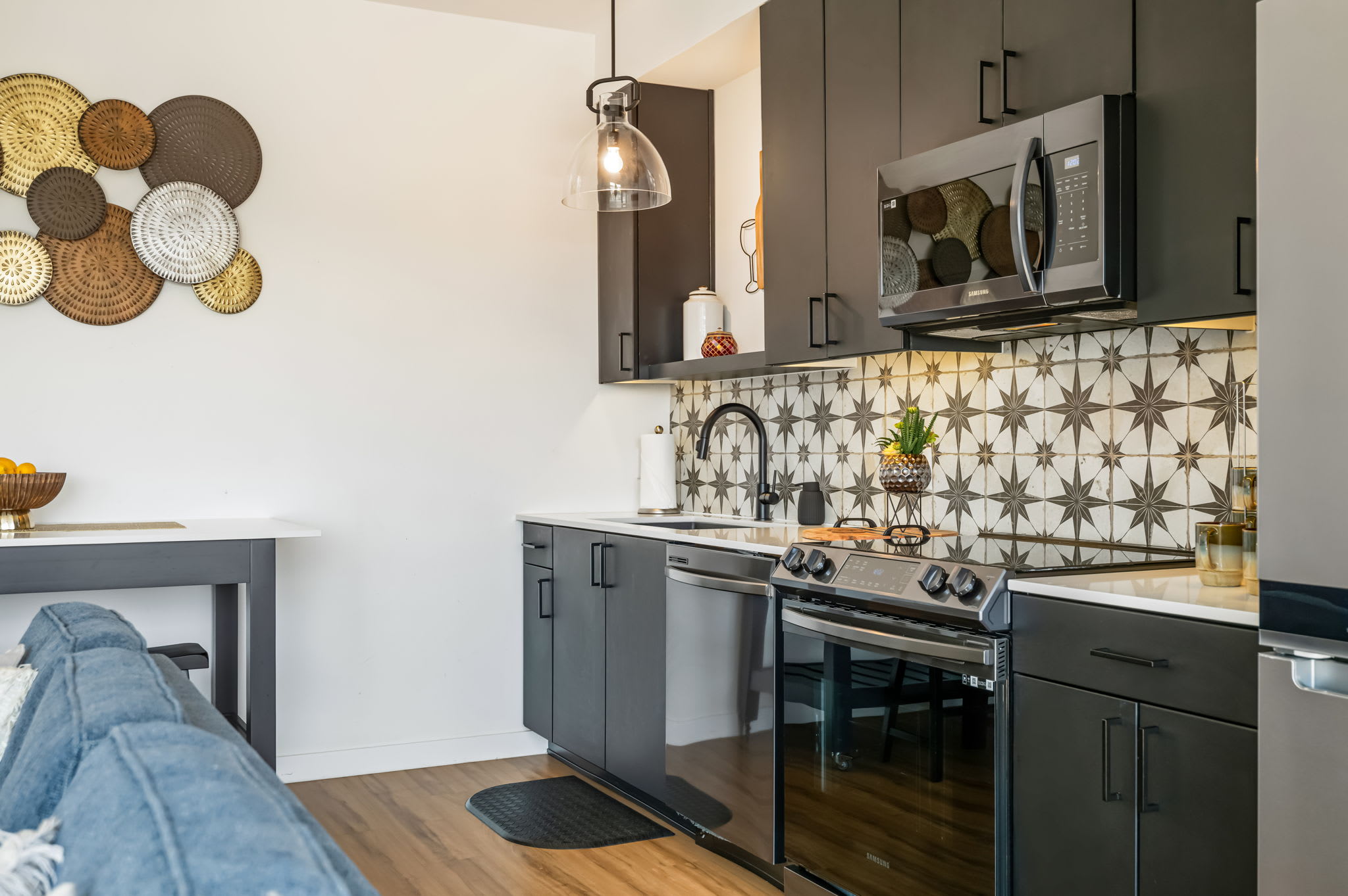 Kitchen with stainless steel appliances and dark cabinetry