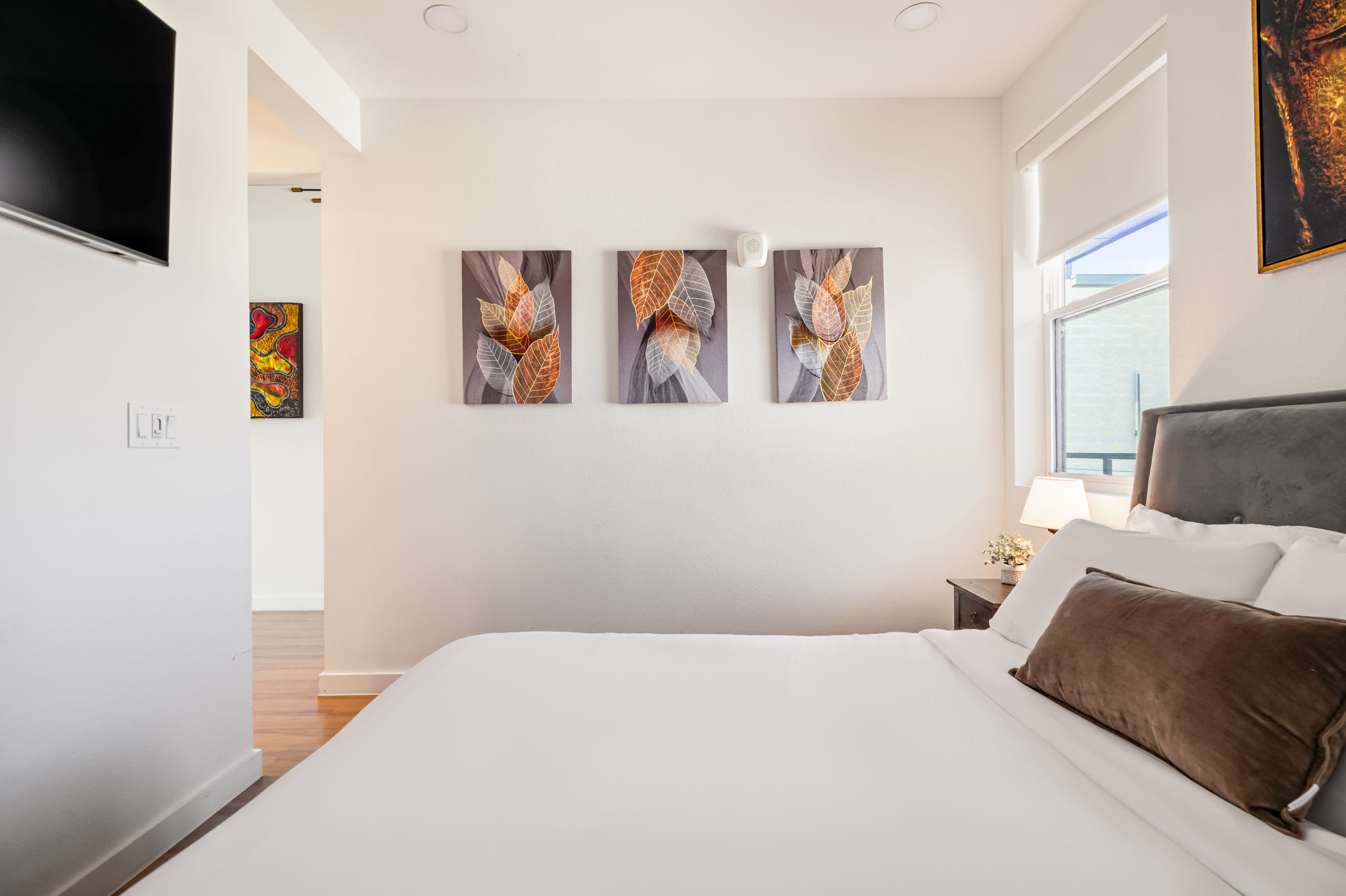 Bedroom with wall art and bright window