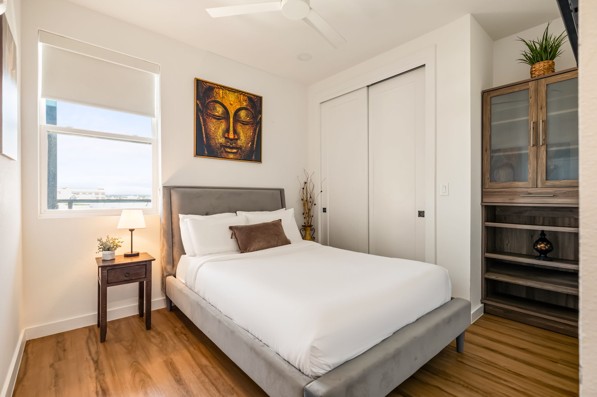 Bedroom with full bed and artwork