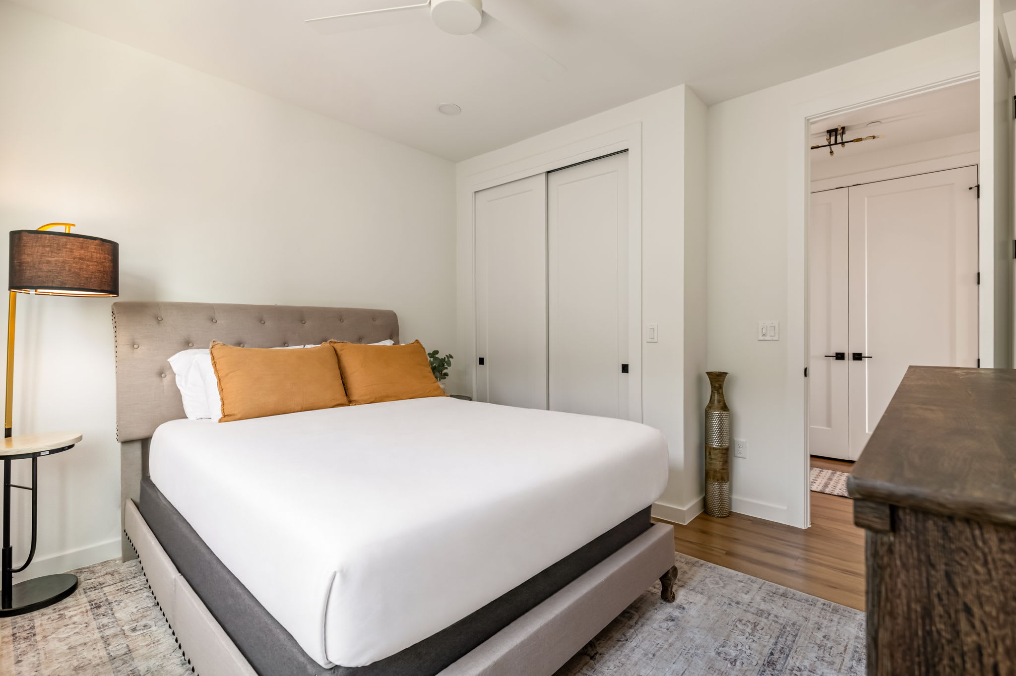 Bedroom with queen bed and warm accents