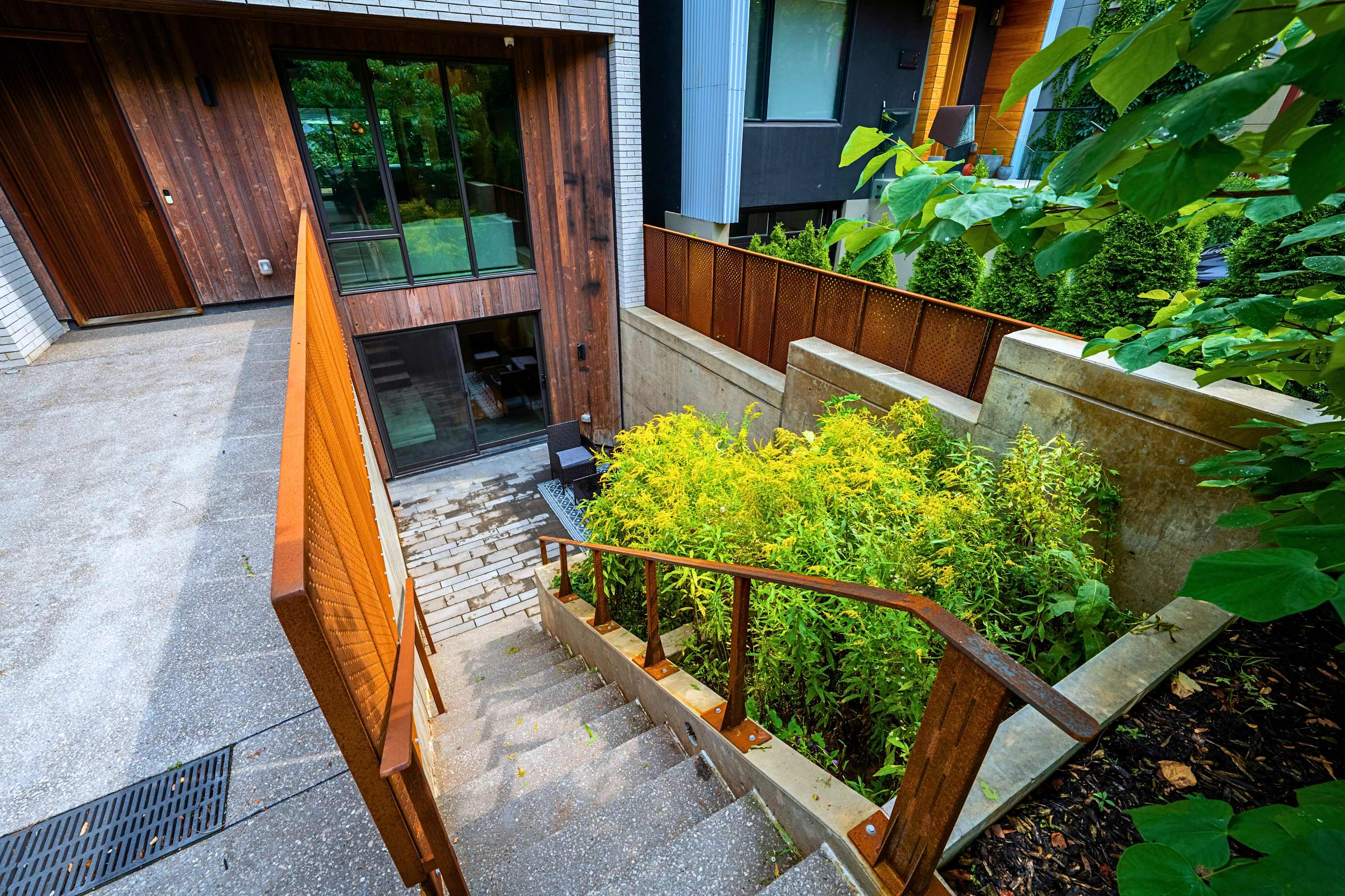 Private exterior stairs leading down into the sunken garden and patio entry