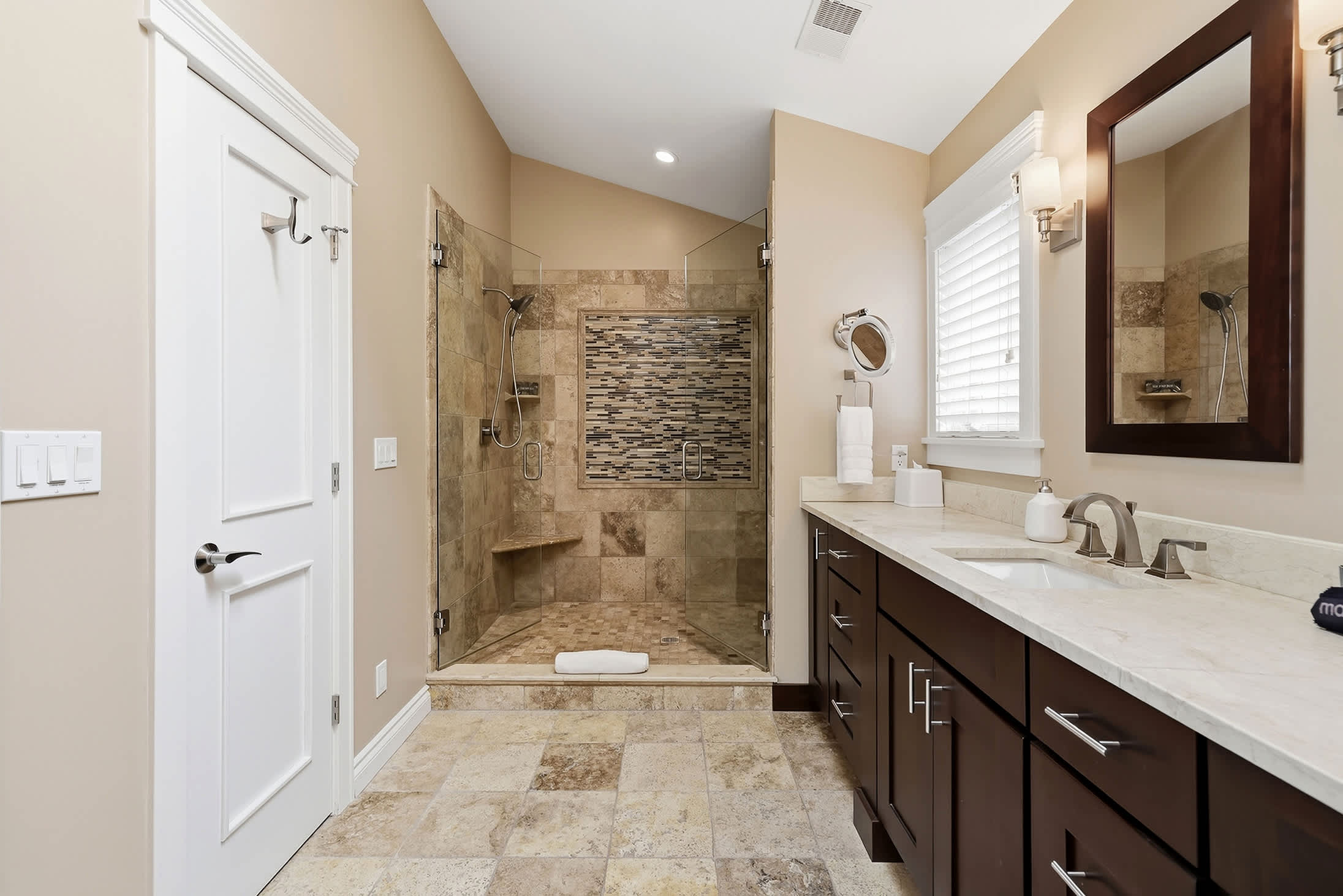 There’s plenty of room for everyone in this bathroom with sleek features and ample counter space.