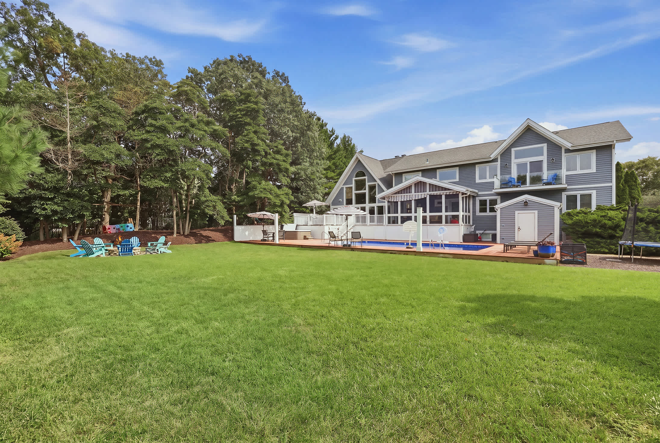 Outdoor area with pool, deck, fire pit and plenty of yard space.