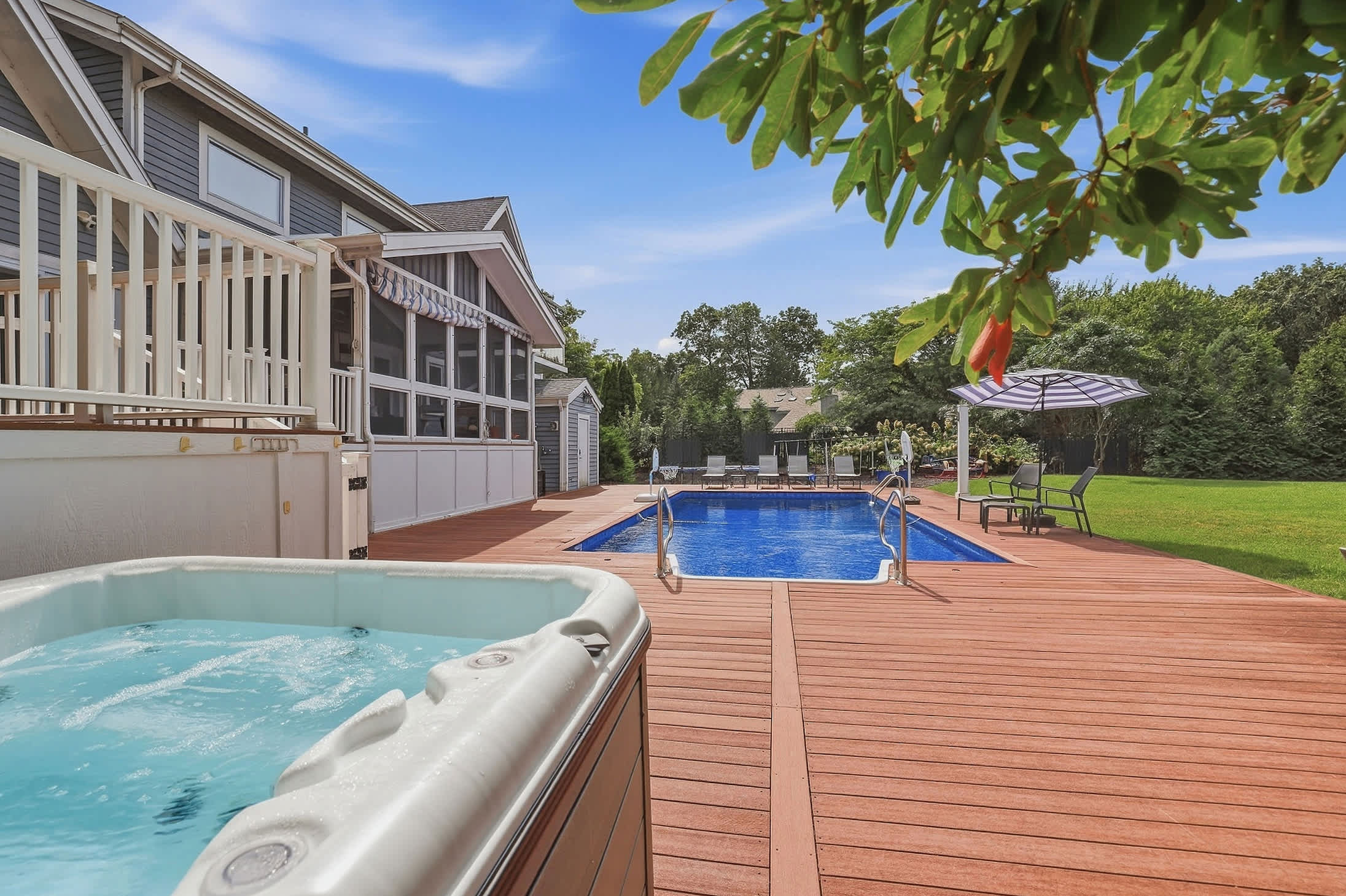 Surrounded by lush greenery, the hot tub offers a peaceful spot to relax and unwind.