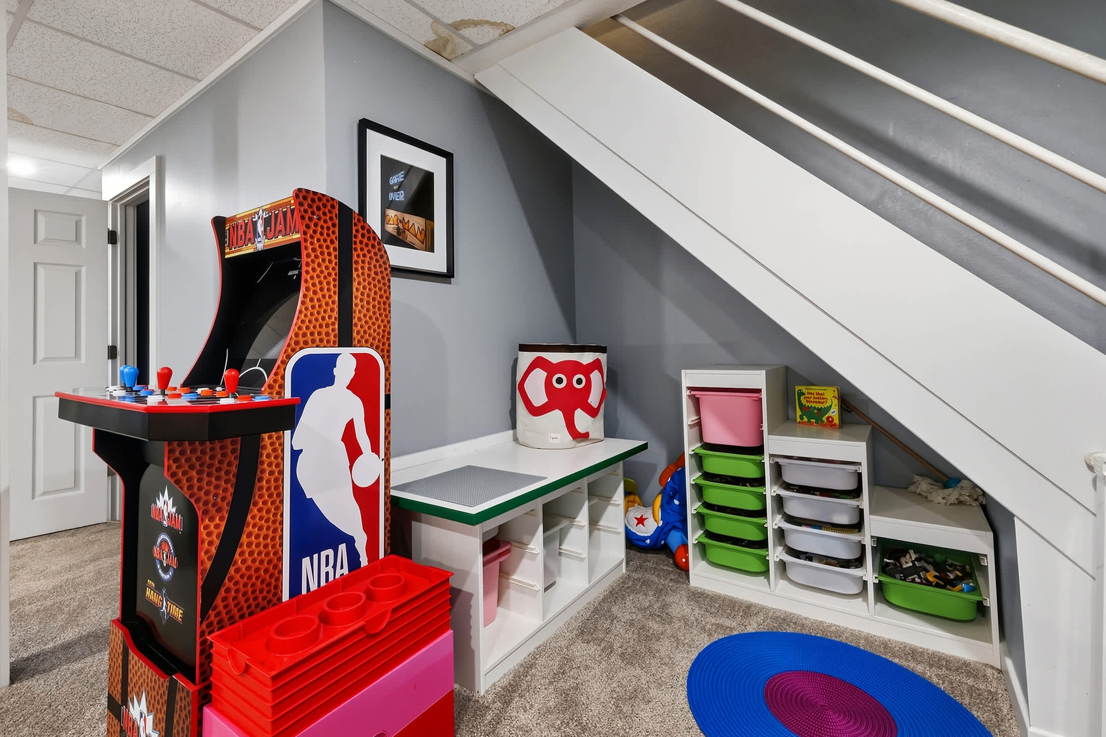 Basement kids zone with NBA Jam, toys and space for creative play.