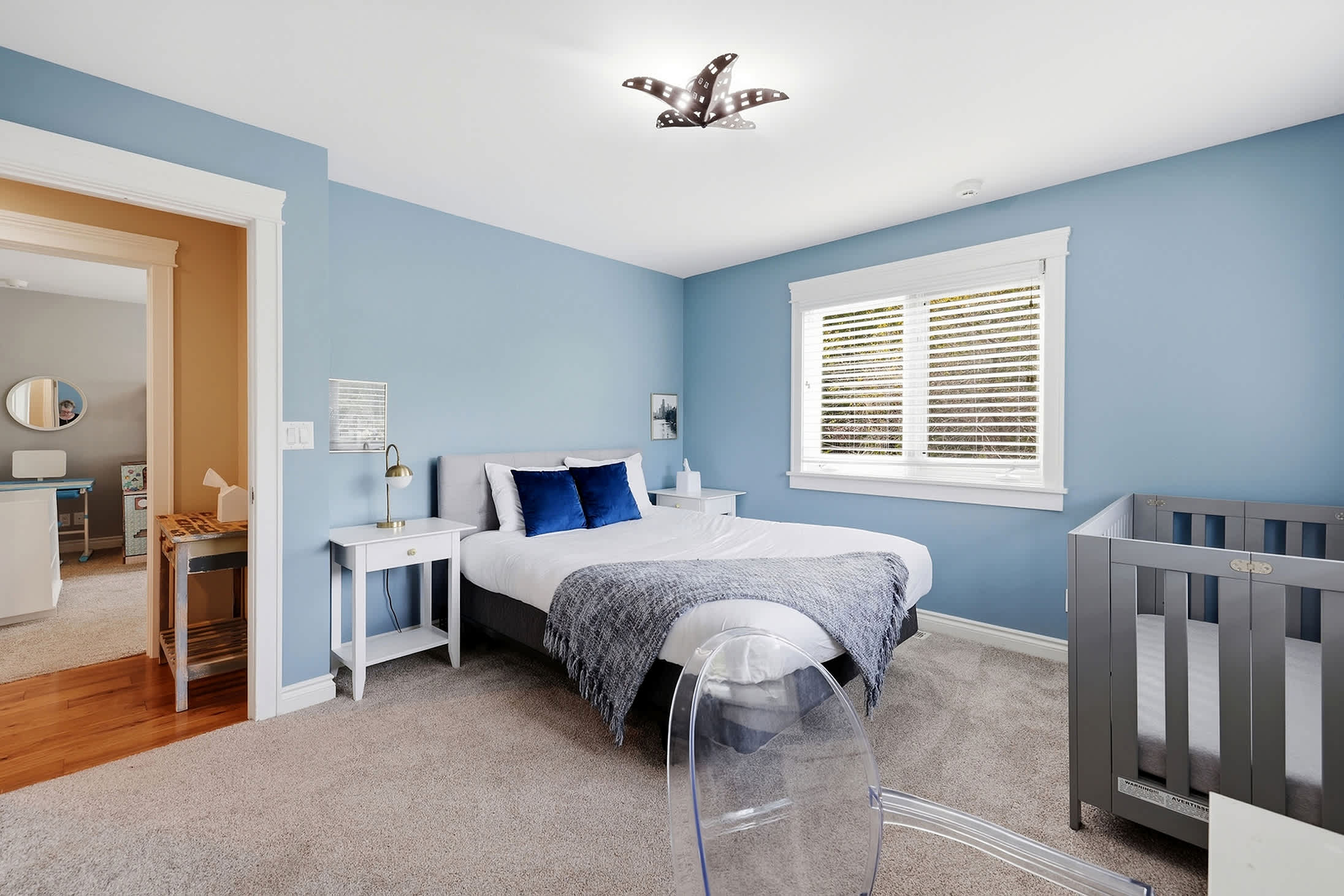 Bedroom 3 is on the main level & has a queen-size bed and a crib.