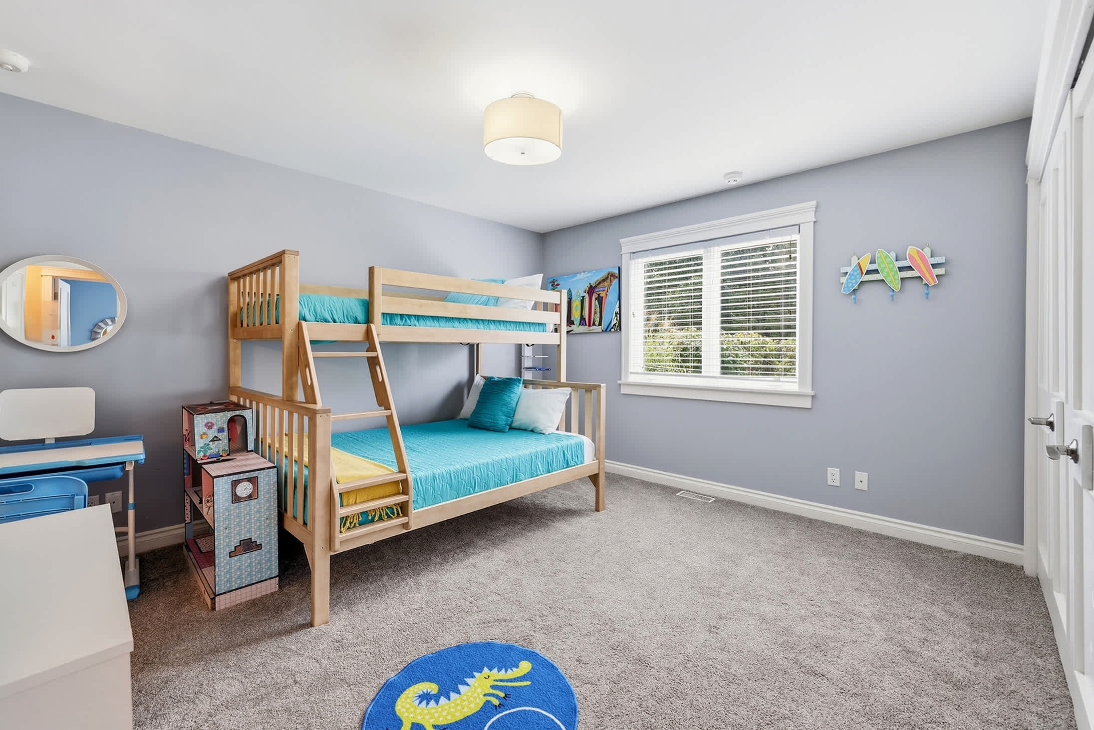 Kids room with bunk sleeping, activity desk and space for play.