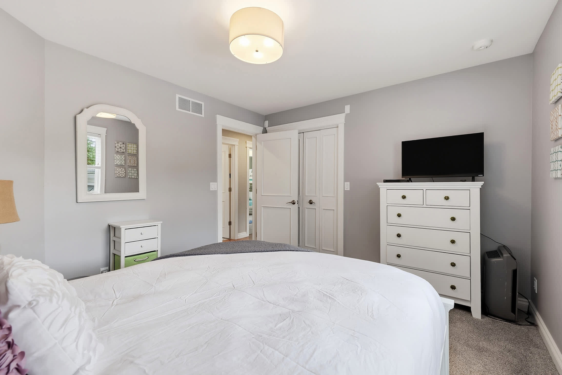 Guest room with TV, dresser and plenty of storage for longer stays.