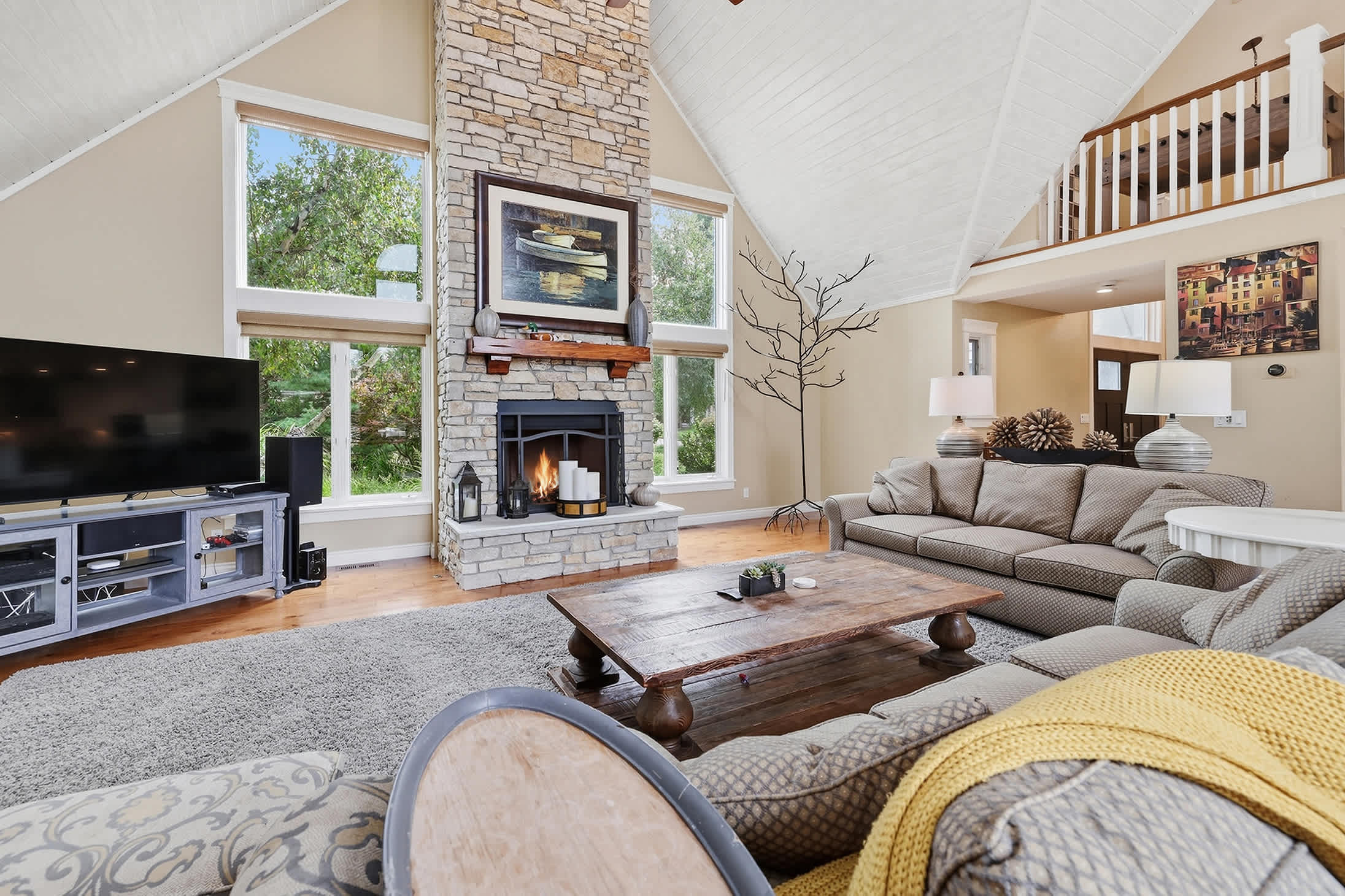 Main living area with fireplace, large TV and spacious seating.