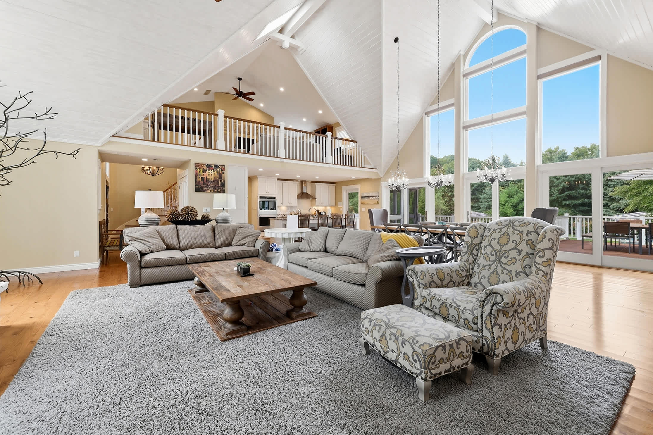 Experience the elegance of this large living room, featuring a magnificent vaulted ceiling and ample natural light.