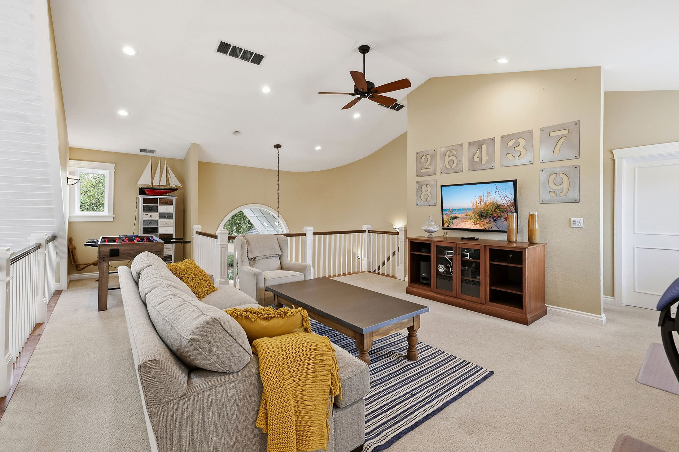 Upstairs seating room with TV and foosball for extra hangout space.