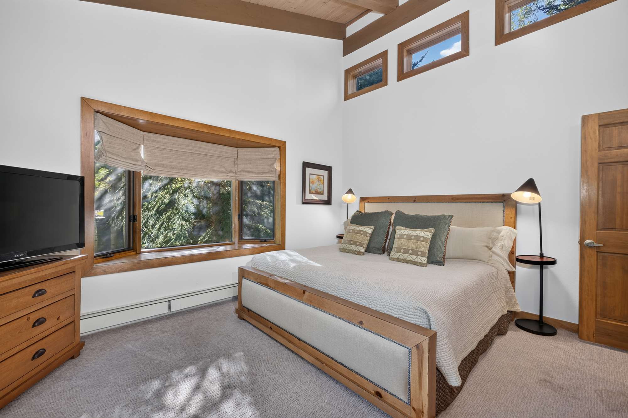 Comfortable king bedroom with a Smart TV, ensuite shower, and private balcony