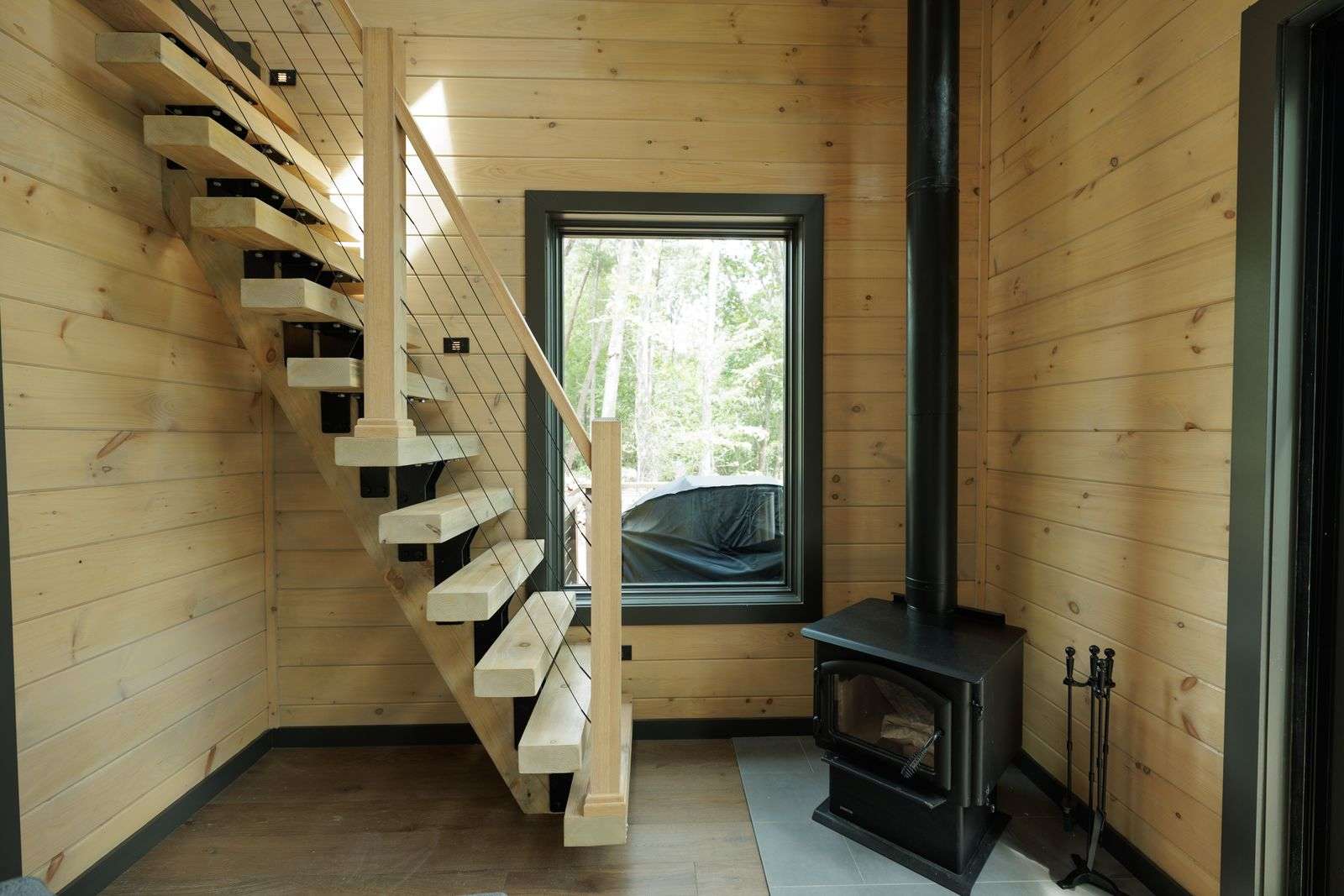 Modern floating staircase leading to the cozy loft area.
