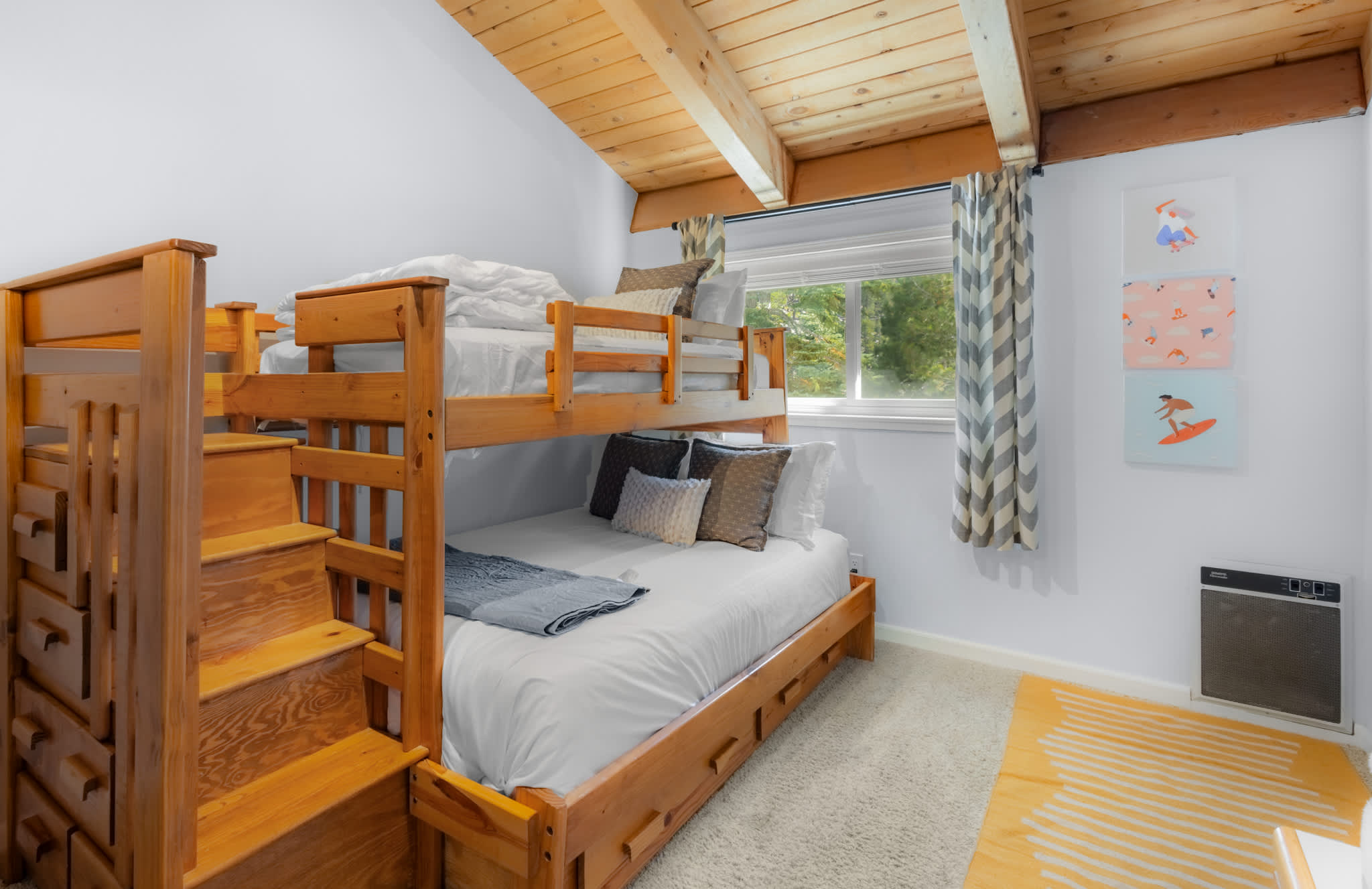 Playful kids’ room featuring a twin-over-full bunk, bean bags, and Smart TV