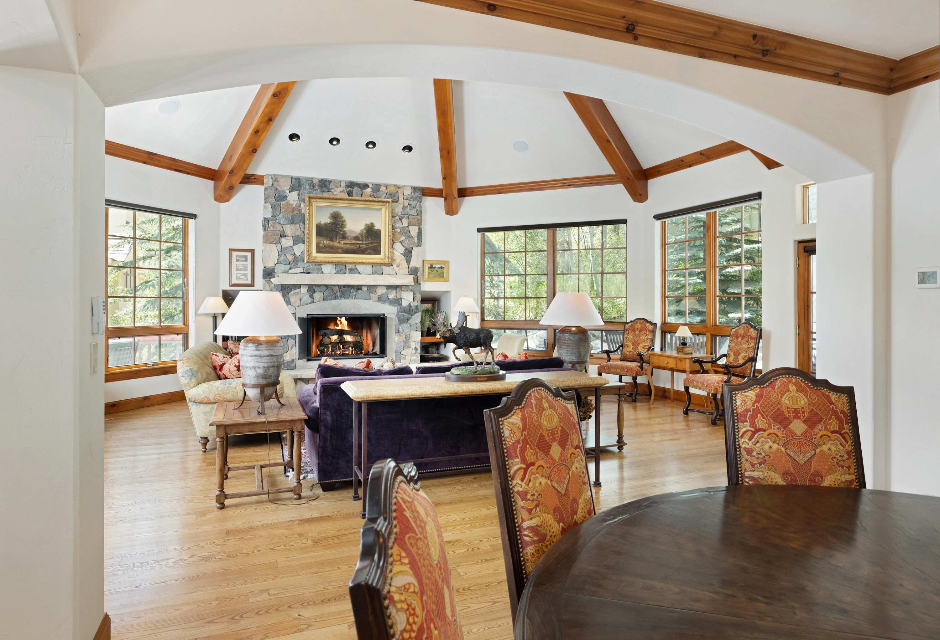 Relax in the light-filled living room with ample seating and a warm fireplace
