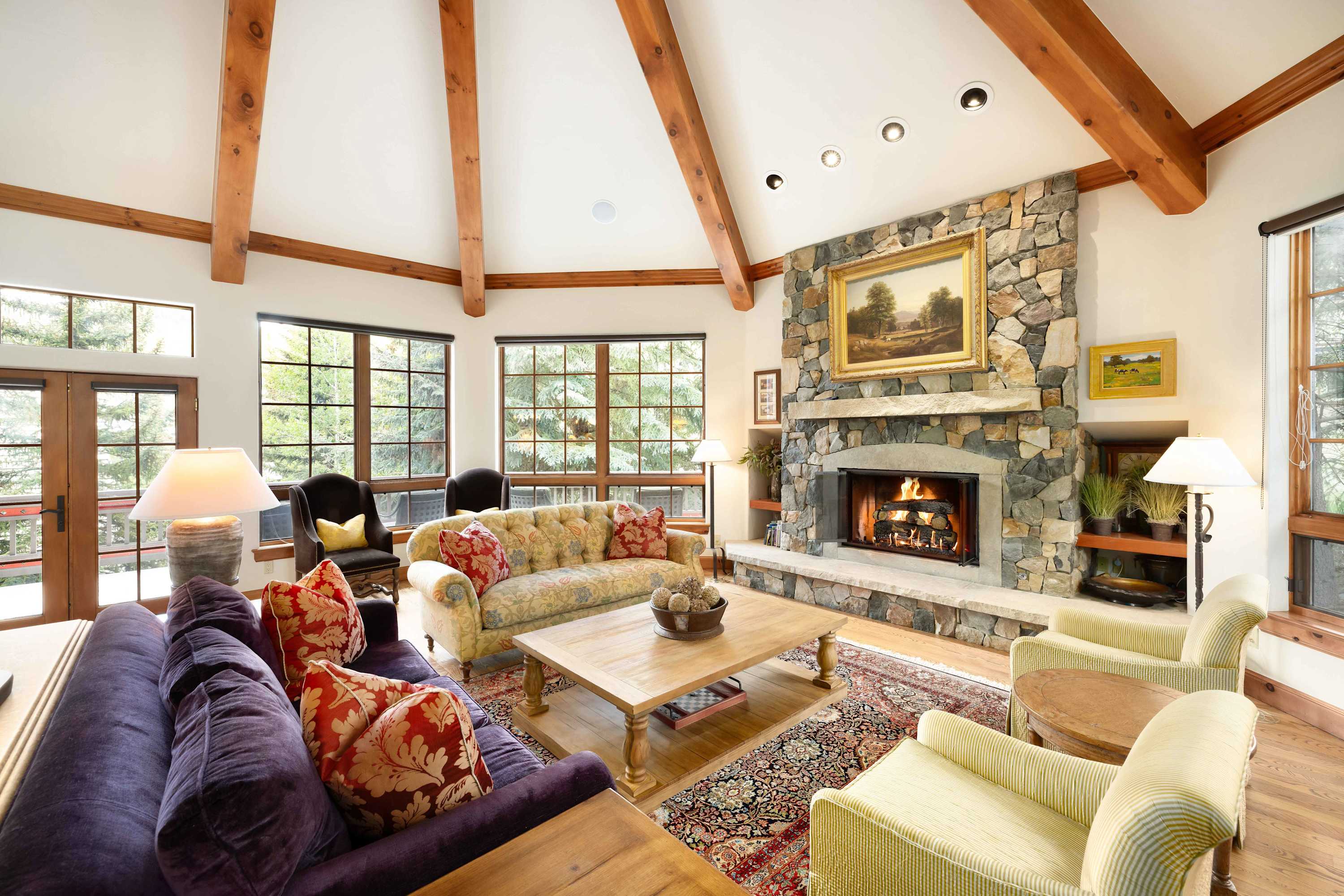 Relax in the light-filled living room with ample seating and a warm fireplace